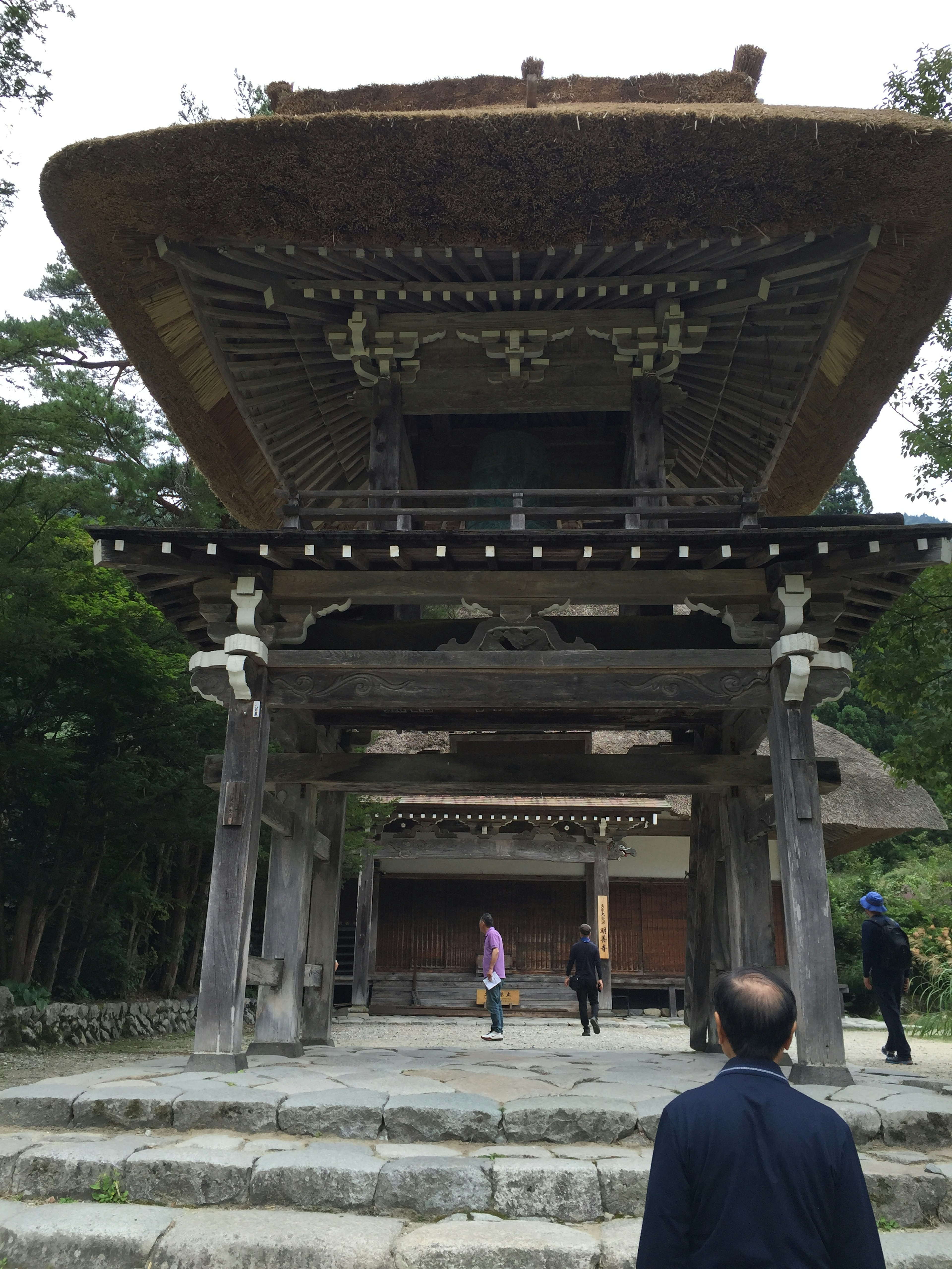 Historic temple gate with visitors approaching