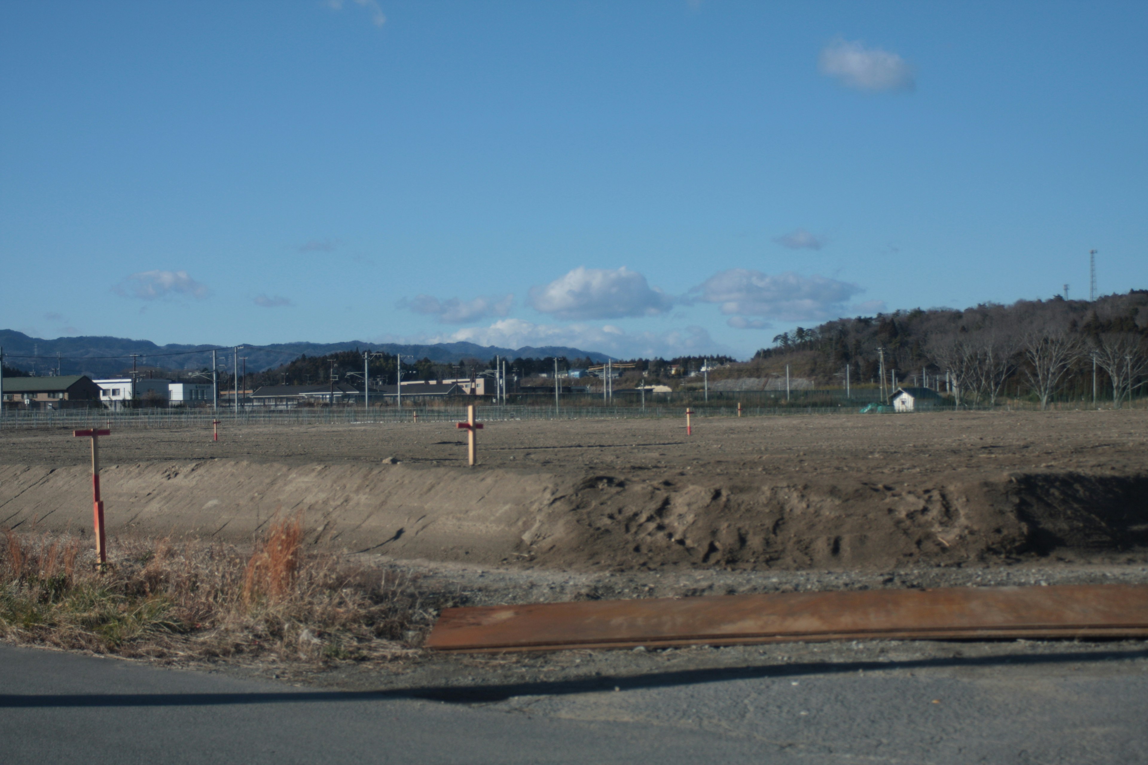 Open field with distant hills and clear blue sky