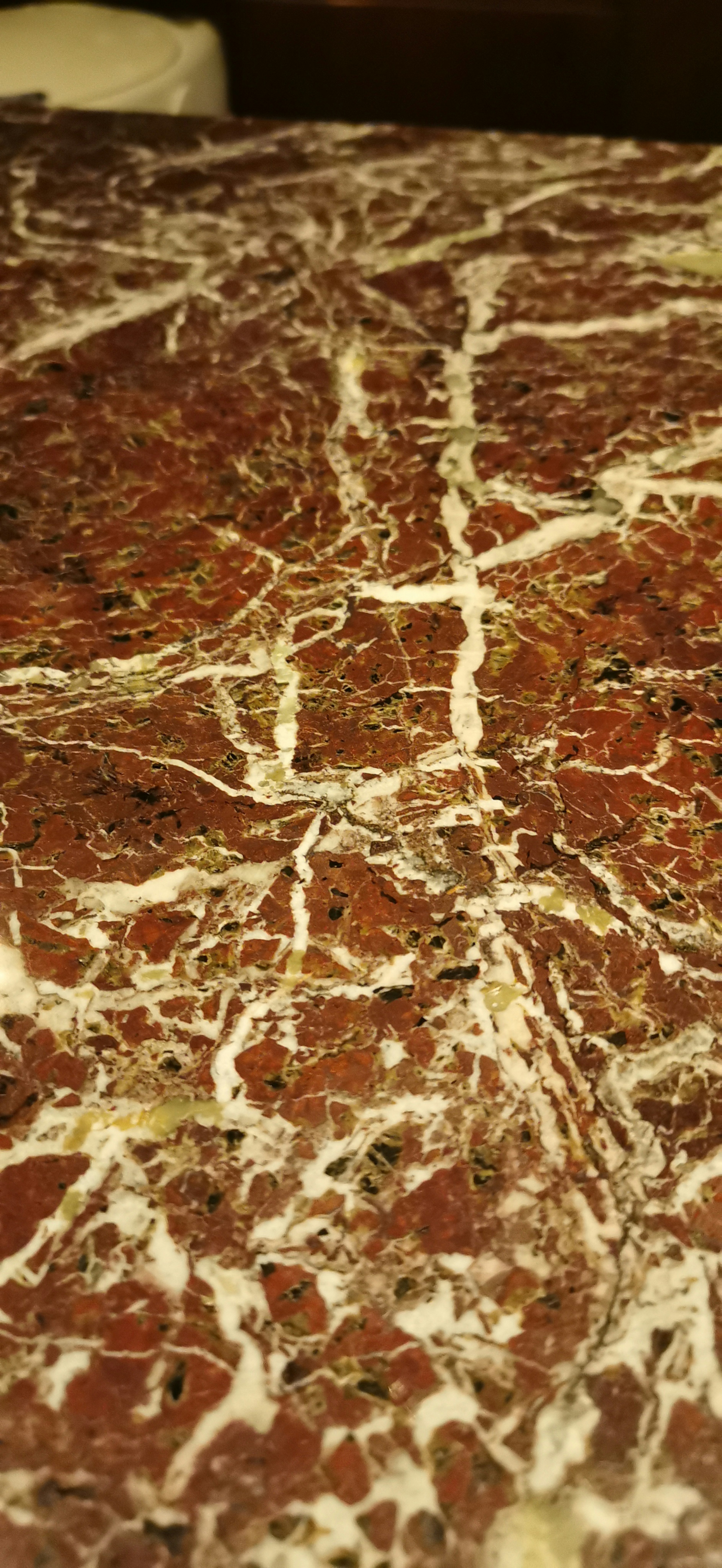 Red marble surface with white veins and patterns