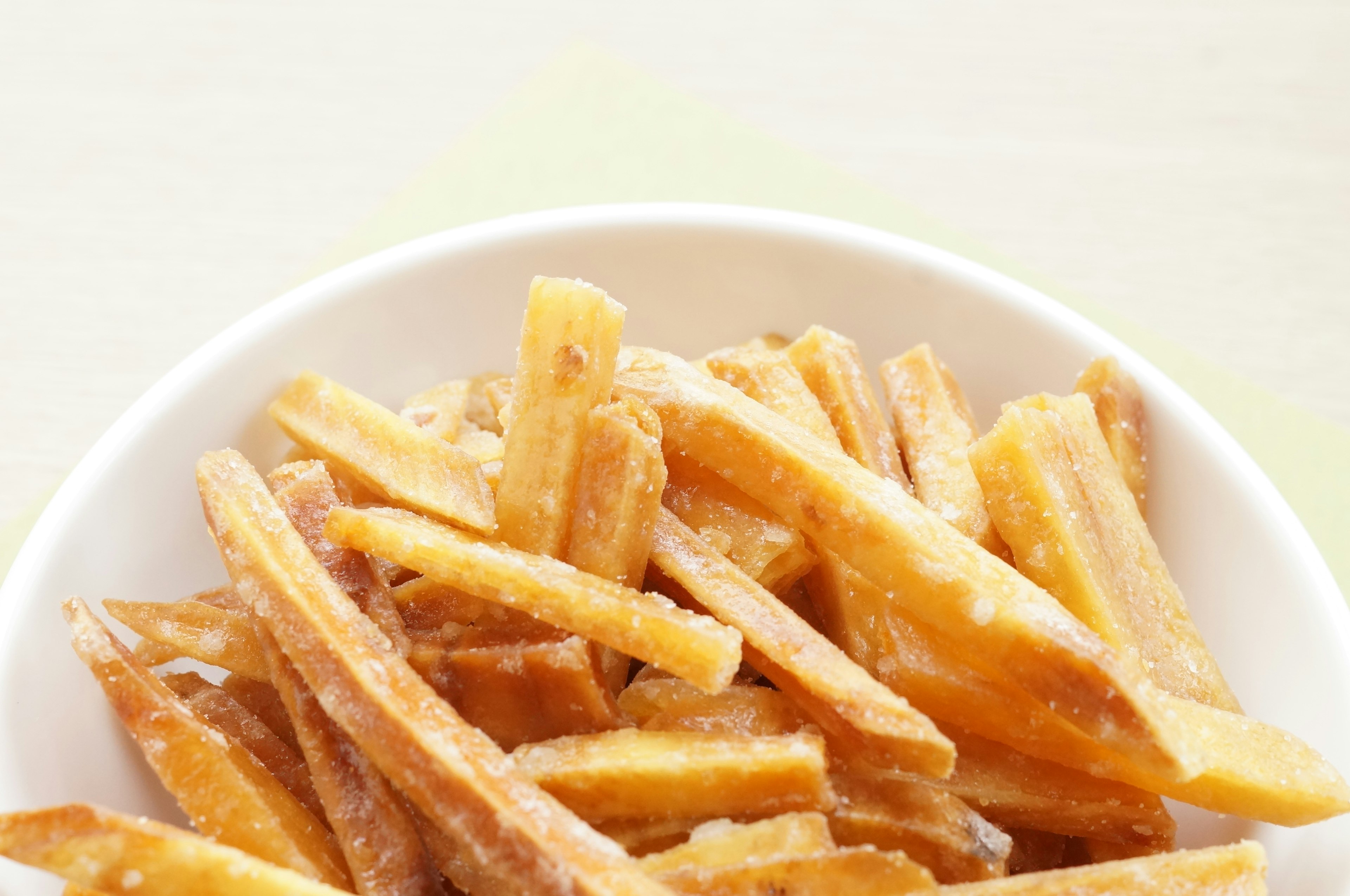 Crispy fried banana strips in a white bowl