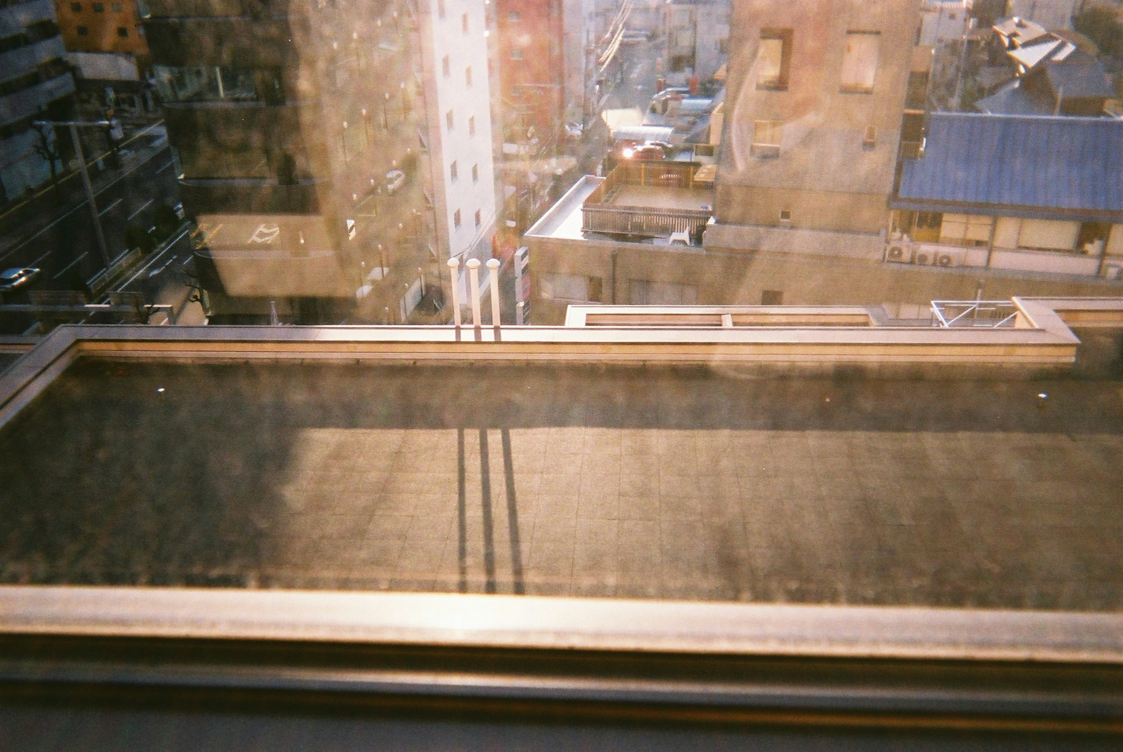 Photo showing an urban view with reflections and shadows from a window