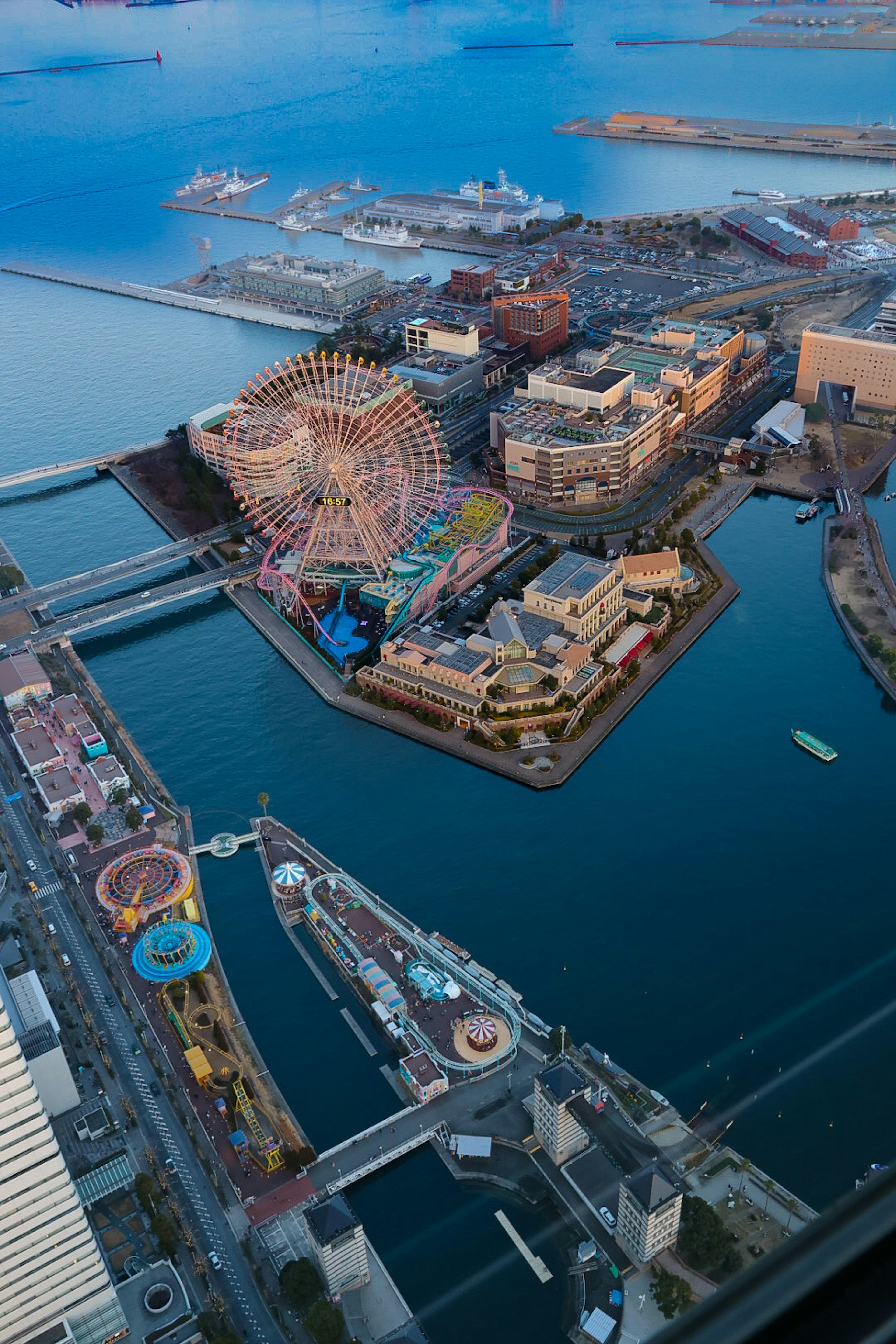 Aerial view of an amusement park with a ferris wheel near the sea