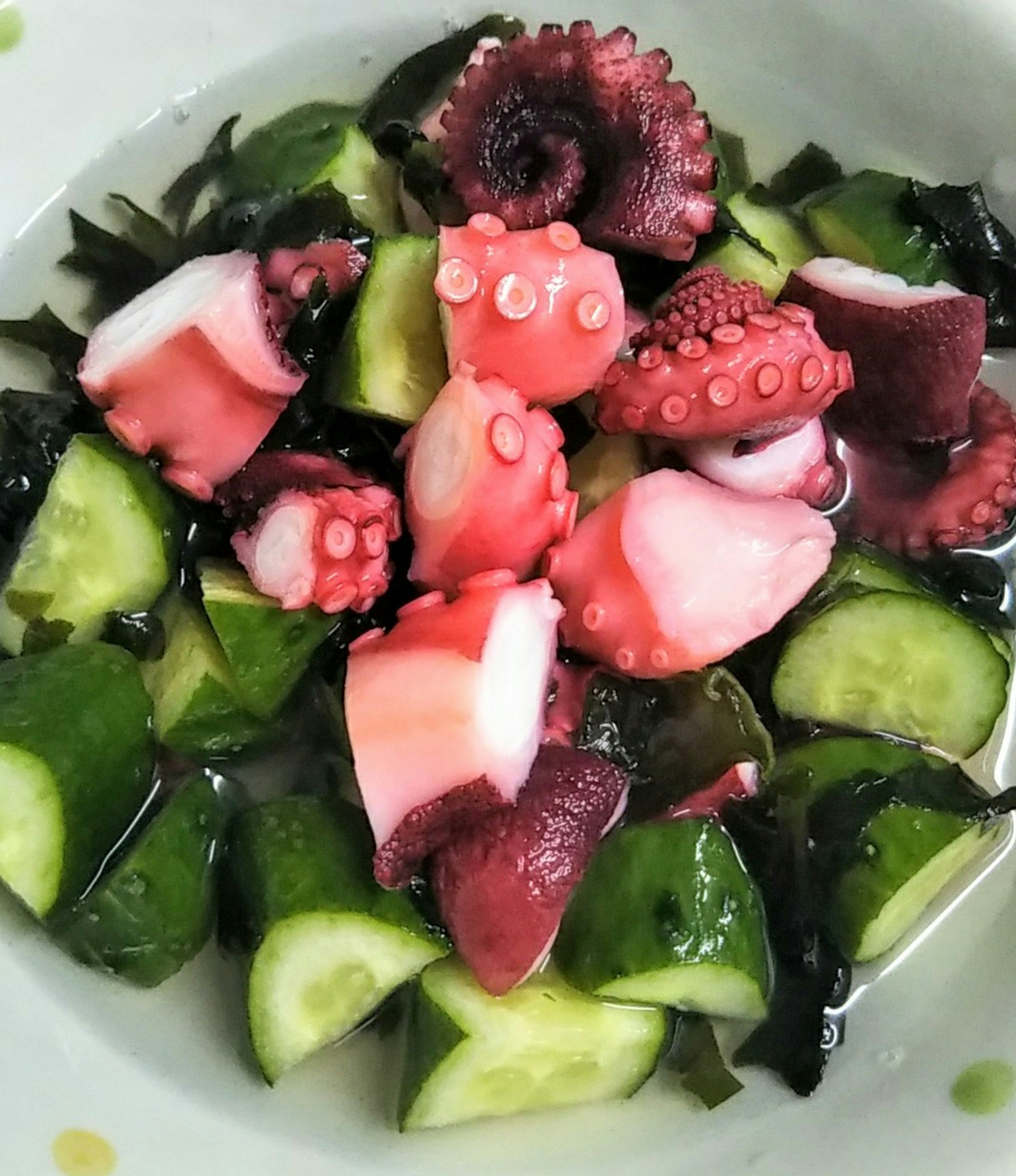 Colorful octopus salad with seaweed and cucumber