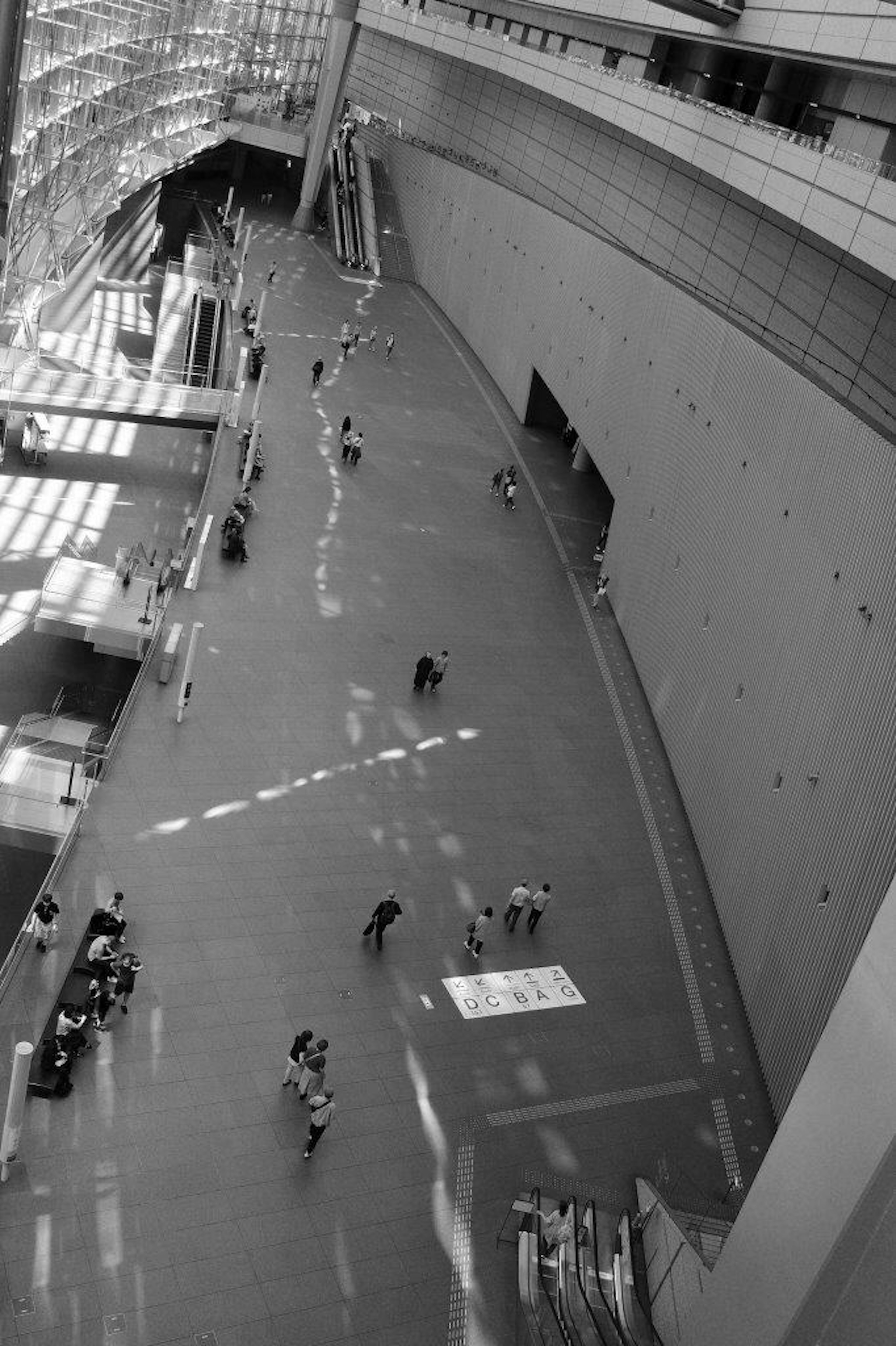 Aerial view of a modern building interior with people walking