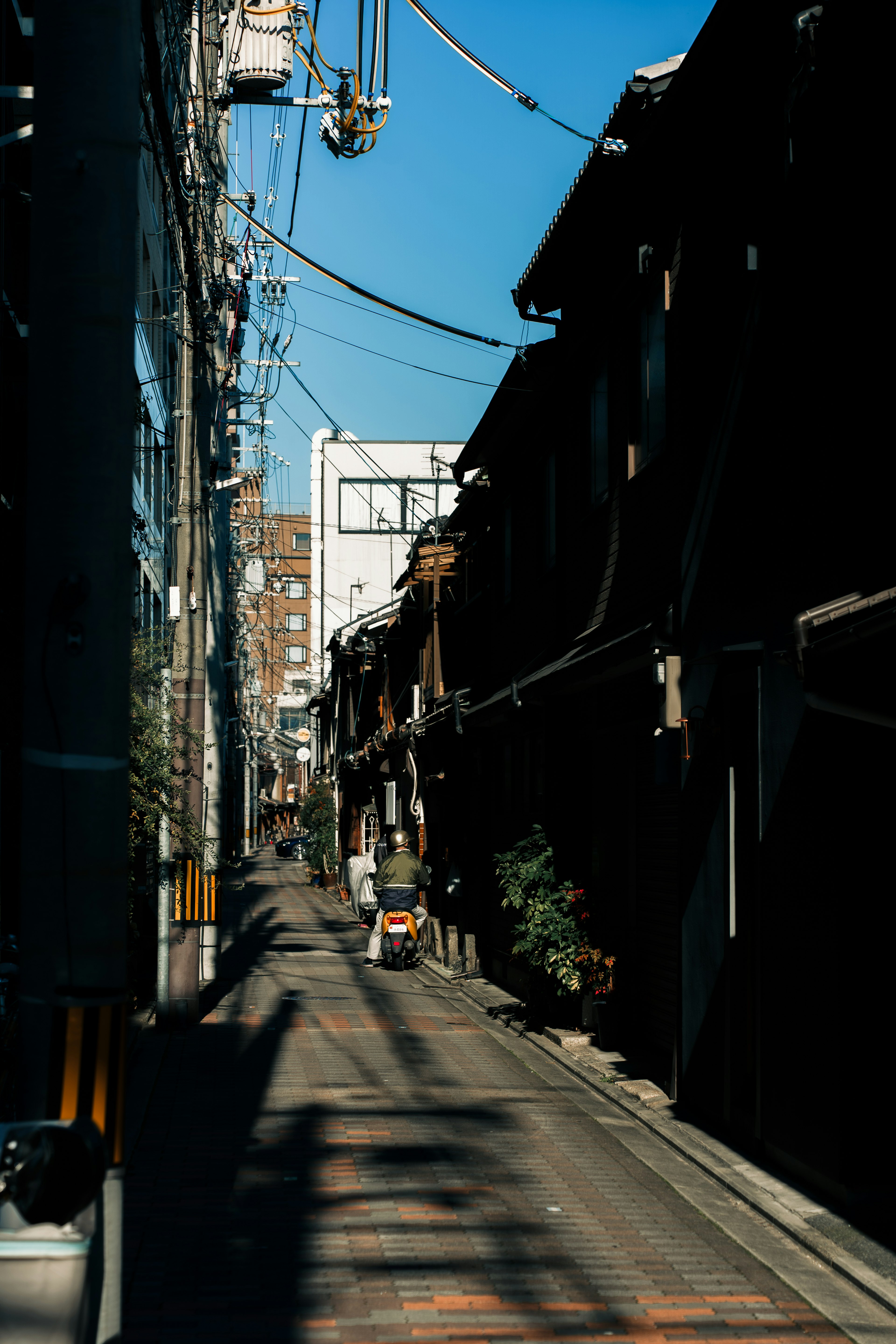 Narrow alley with old buildings and clear blue sky