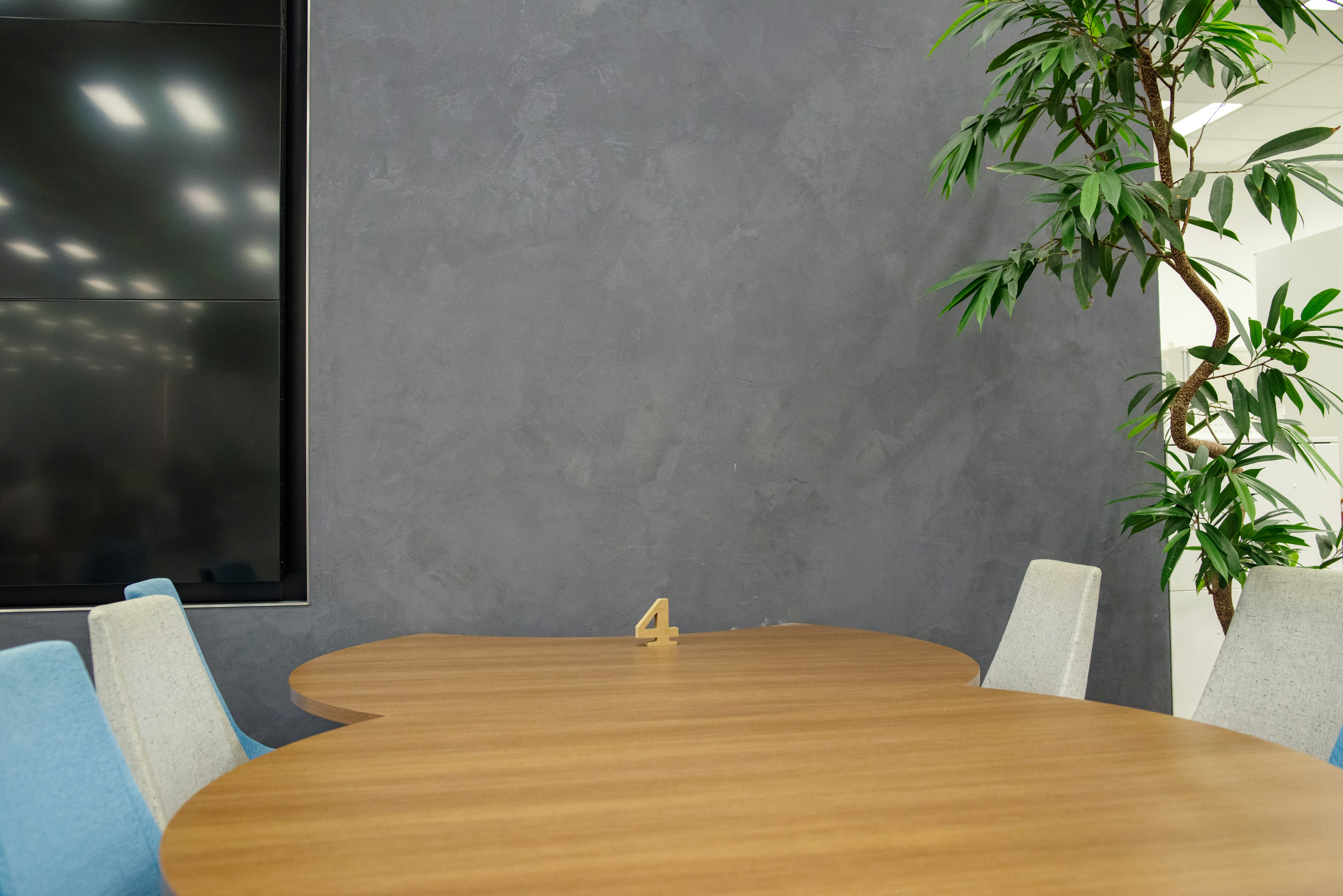 Modern conference room with a unique table and indoor plant