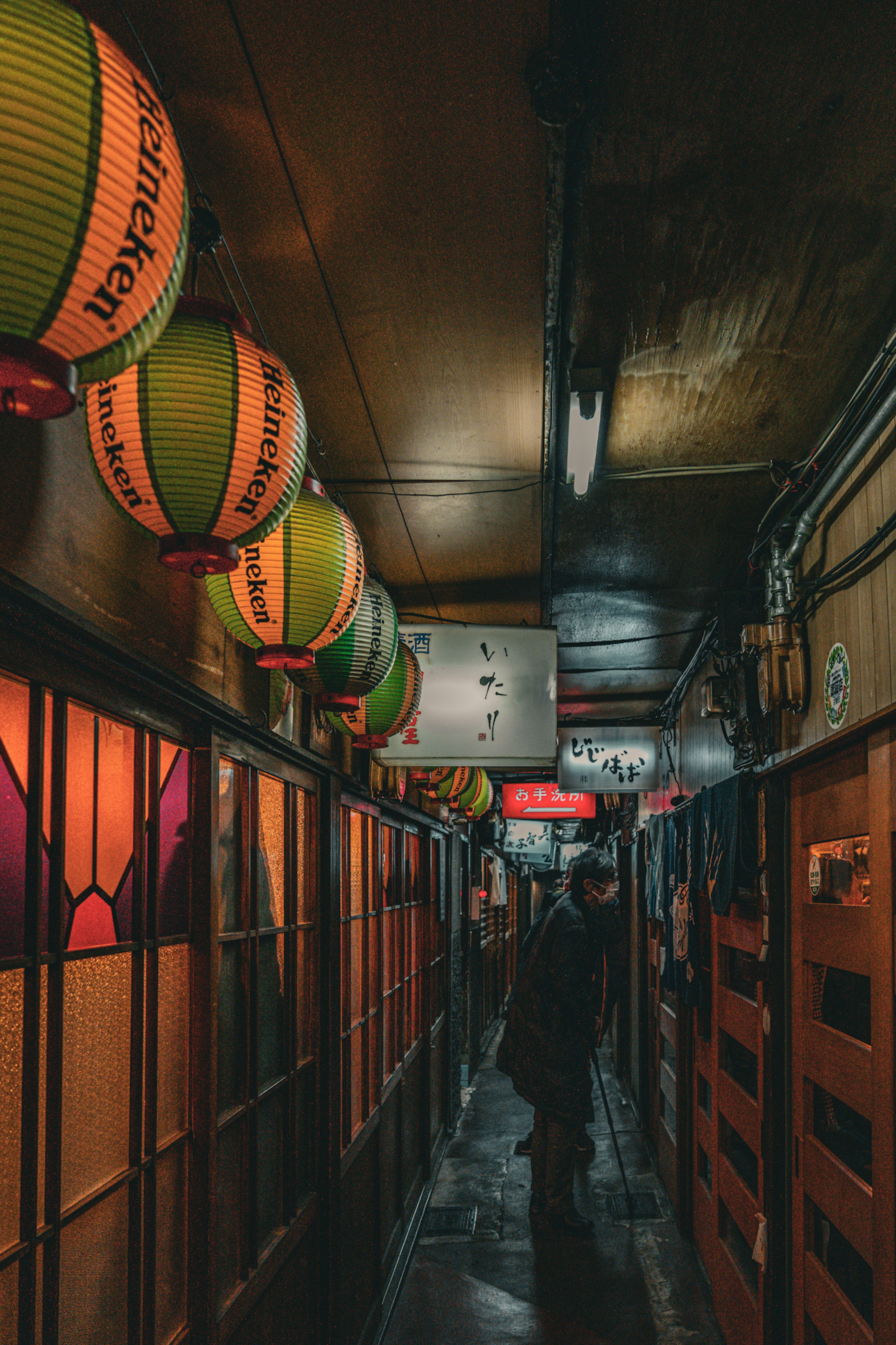 Narrow corridor with colorful lanterns and warm lighting