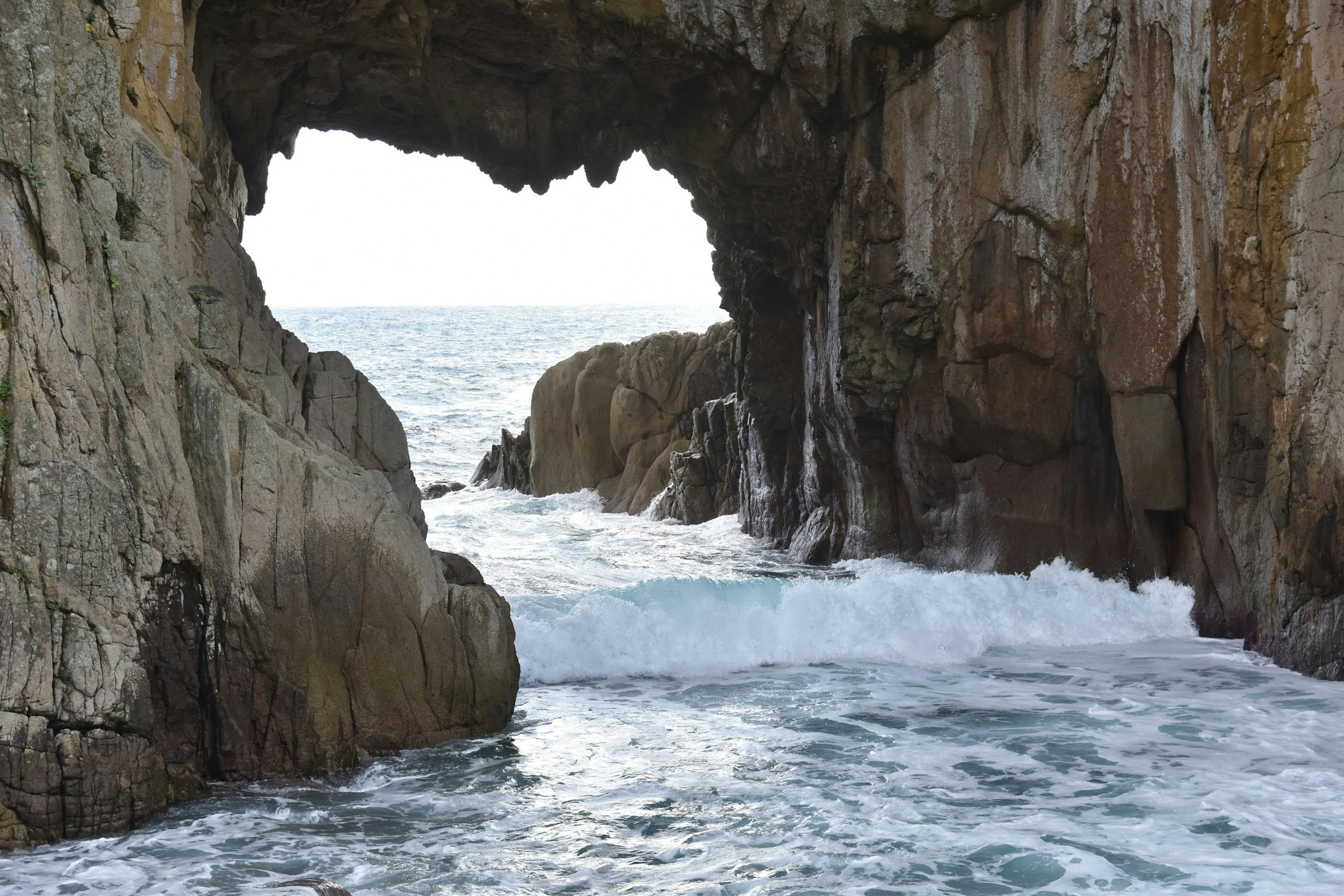 Rock arch over ocean waves