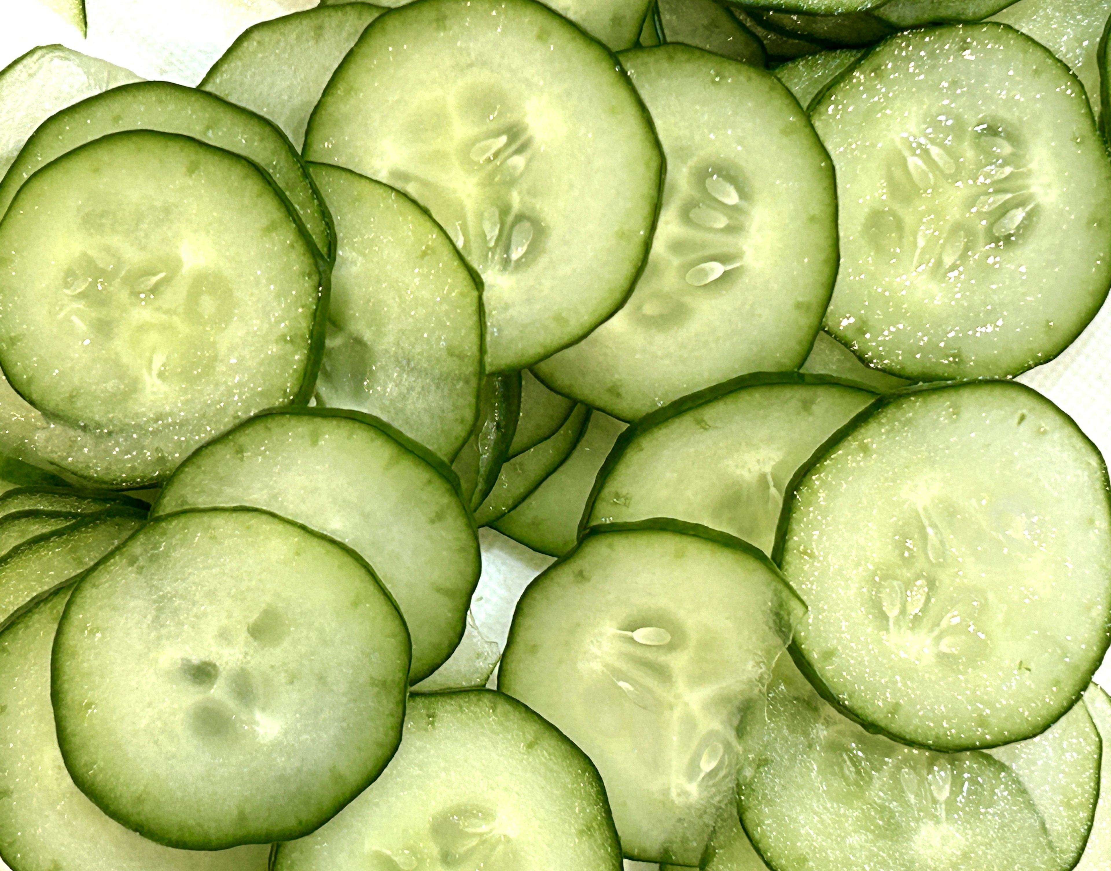 Thinly sliced cucumber rounds arranged closely together