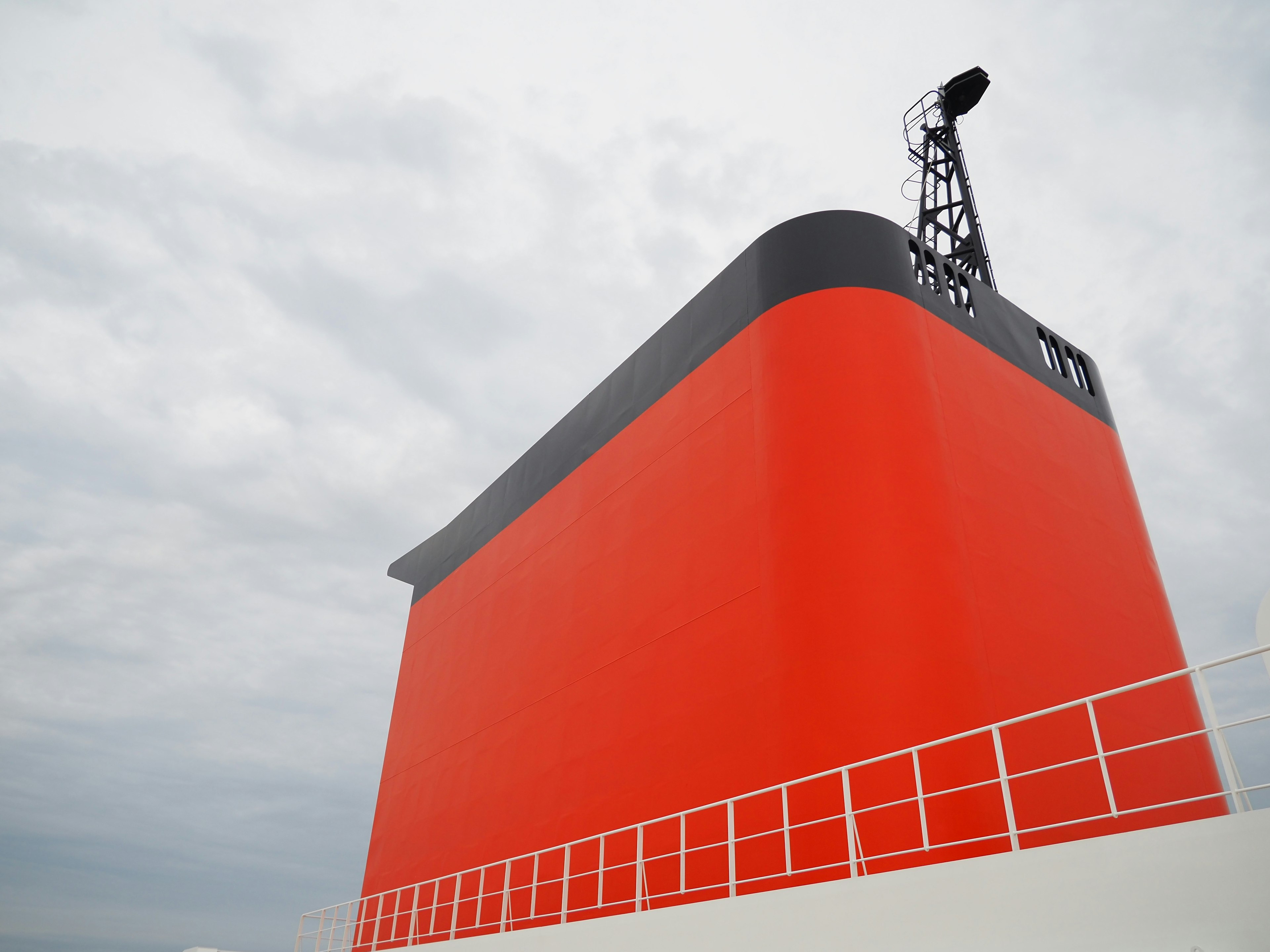 Image of a ship's section featuring a red wall and black roof