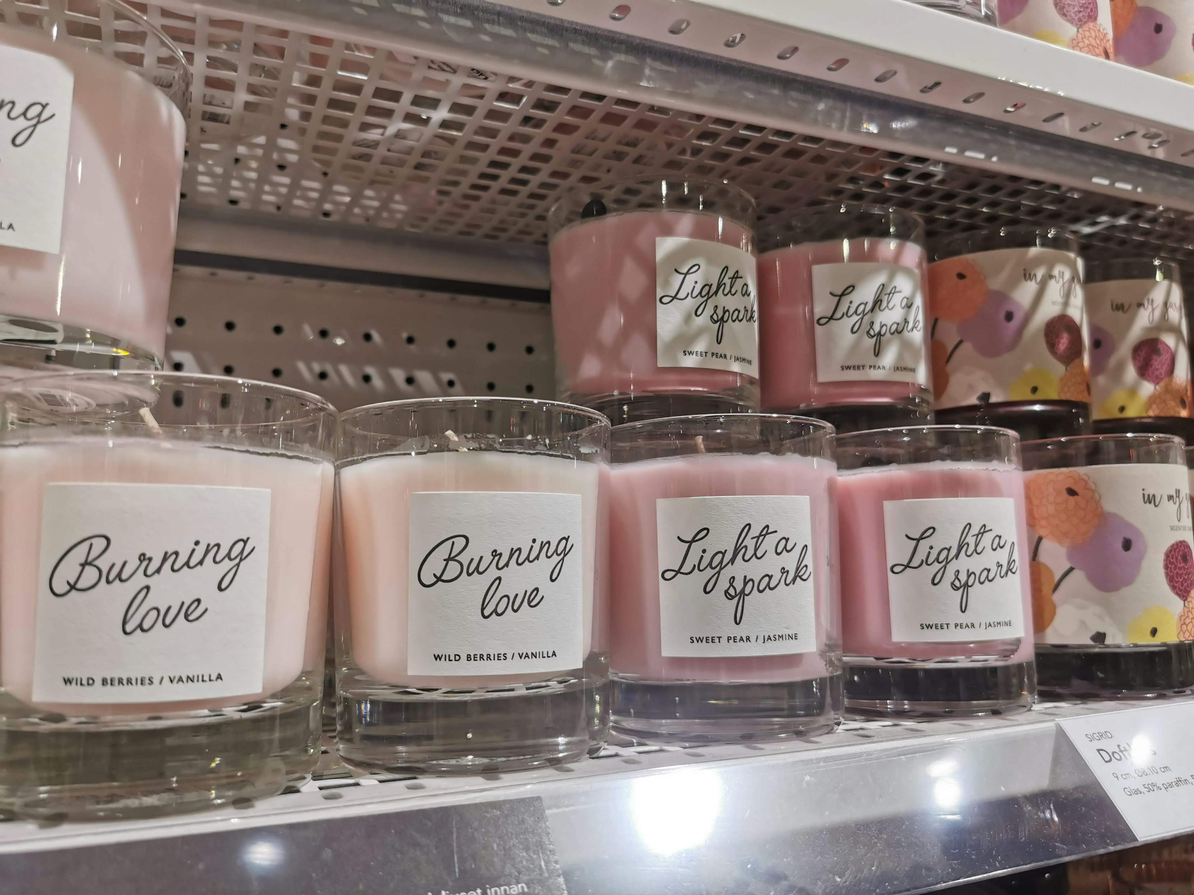 Various scented candles displayed on a shelf