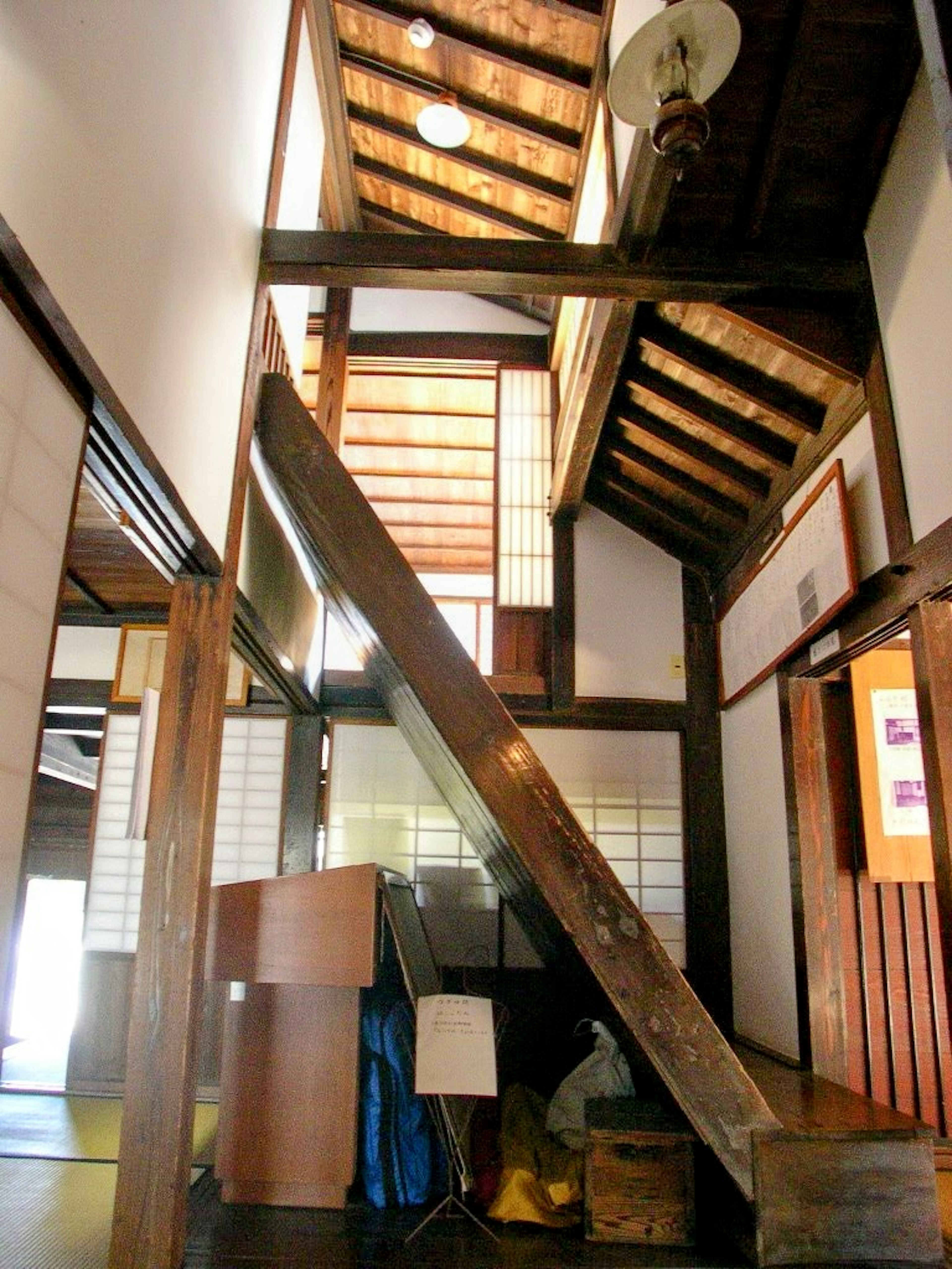 Traditional Japanese interior featuring wooden beams and staircase