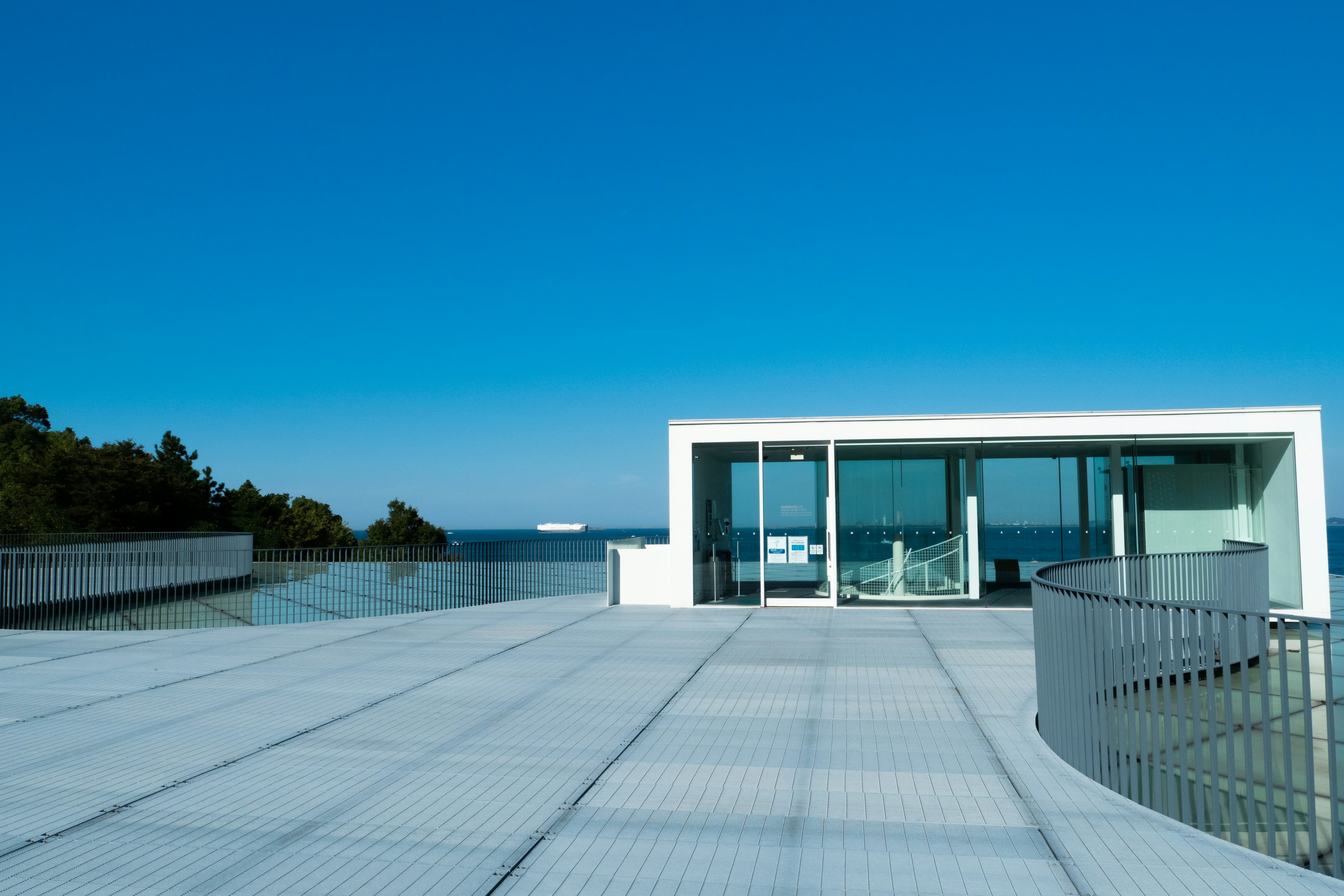 Modern white house with a spacious terrace under a clear blue sky