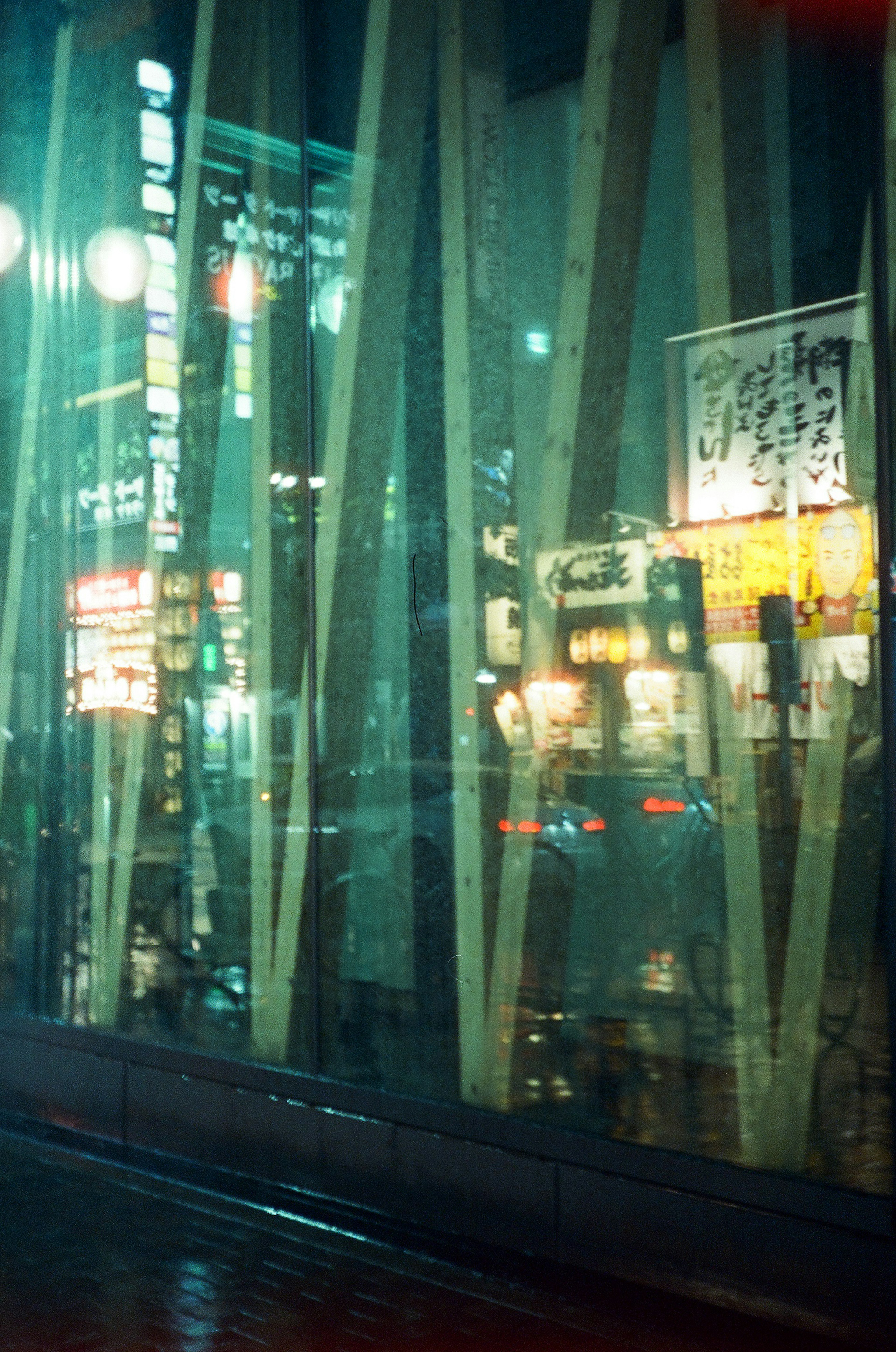 Night cityscape with reflections and lights through glass