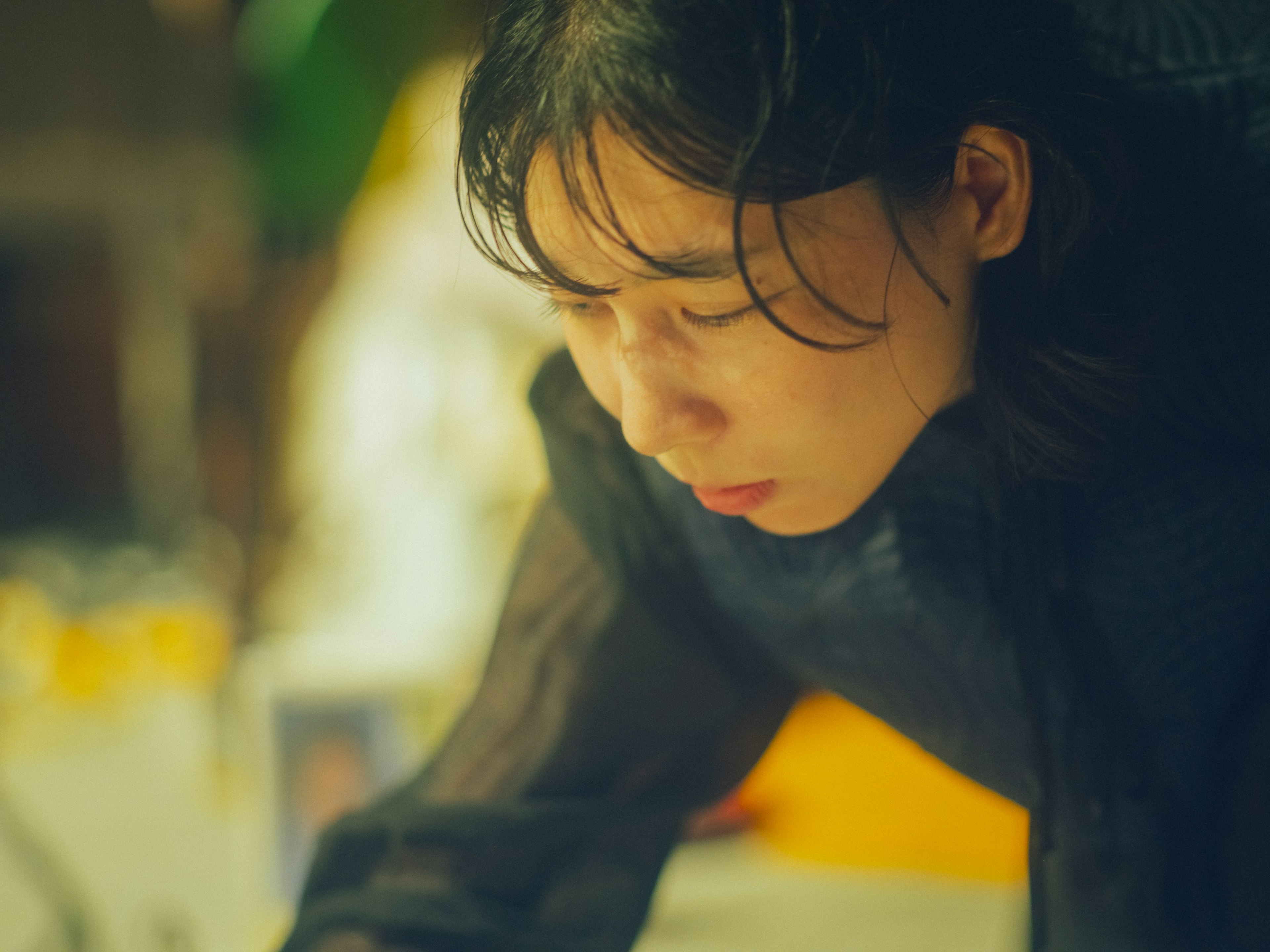 Young woman in profile focused on her work with a blurred background