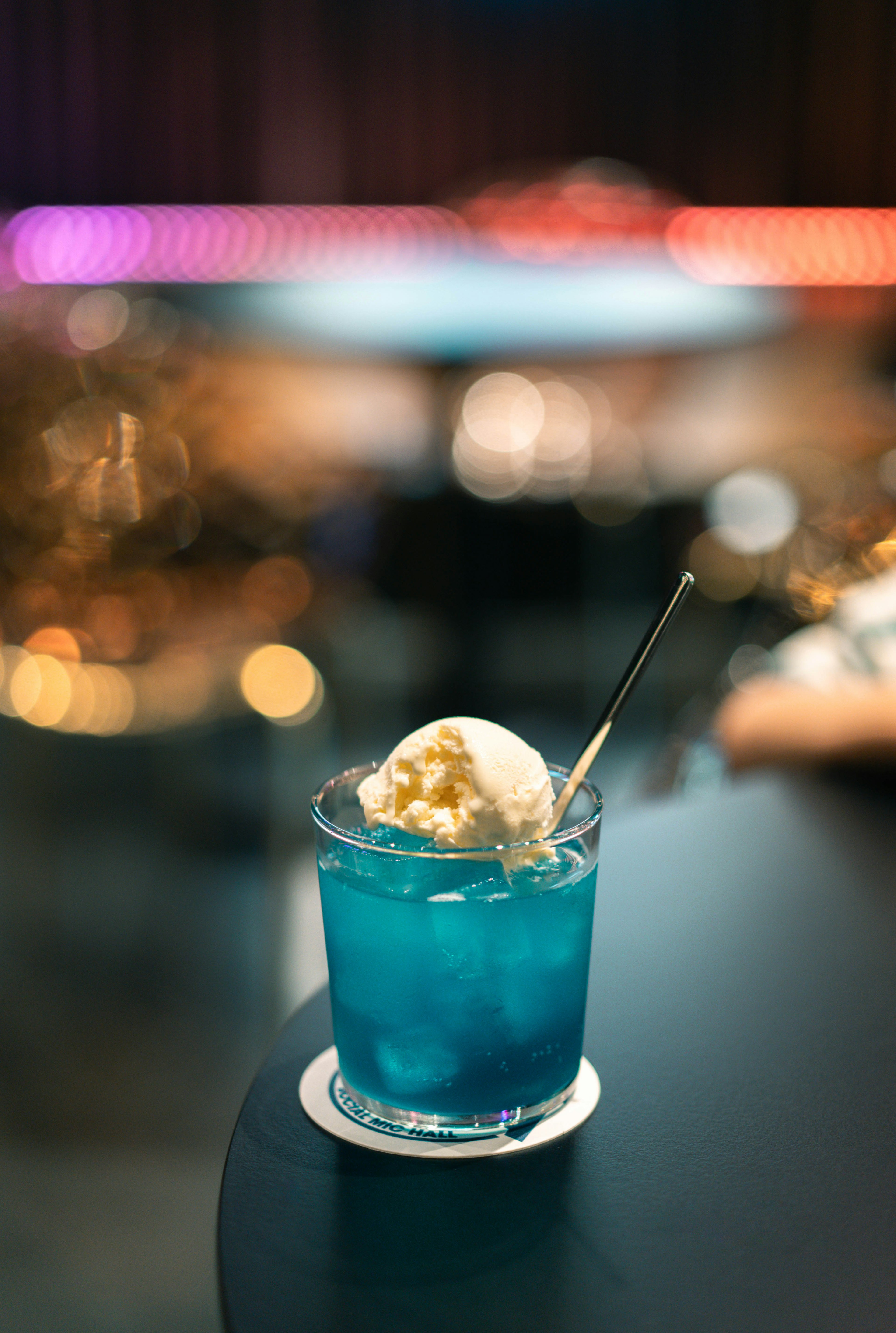 Blue cocktail with ice cream dessert on a table