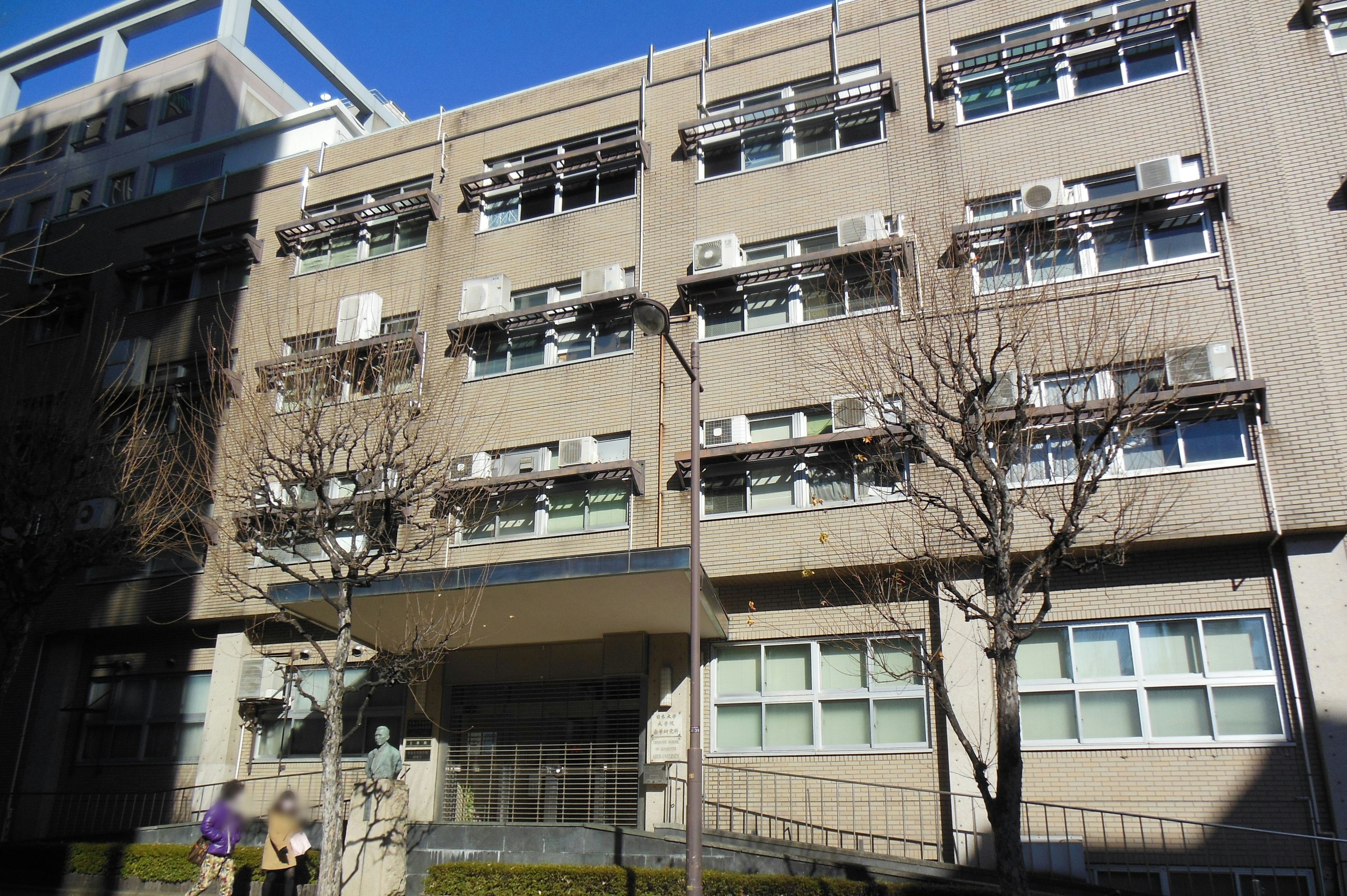 Commercial building exterior featuring multiple air conditioning units