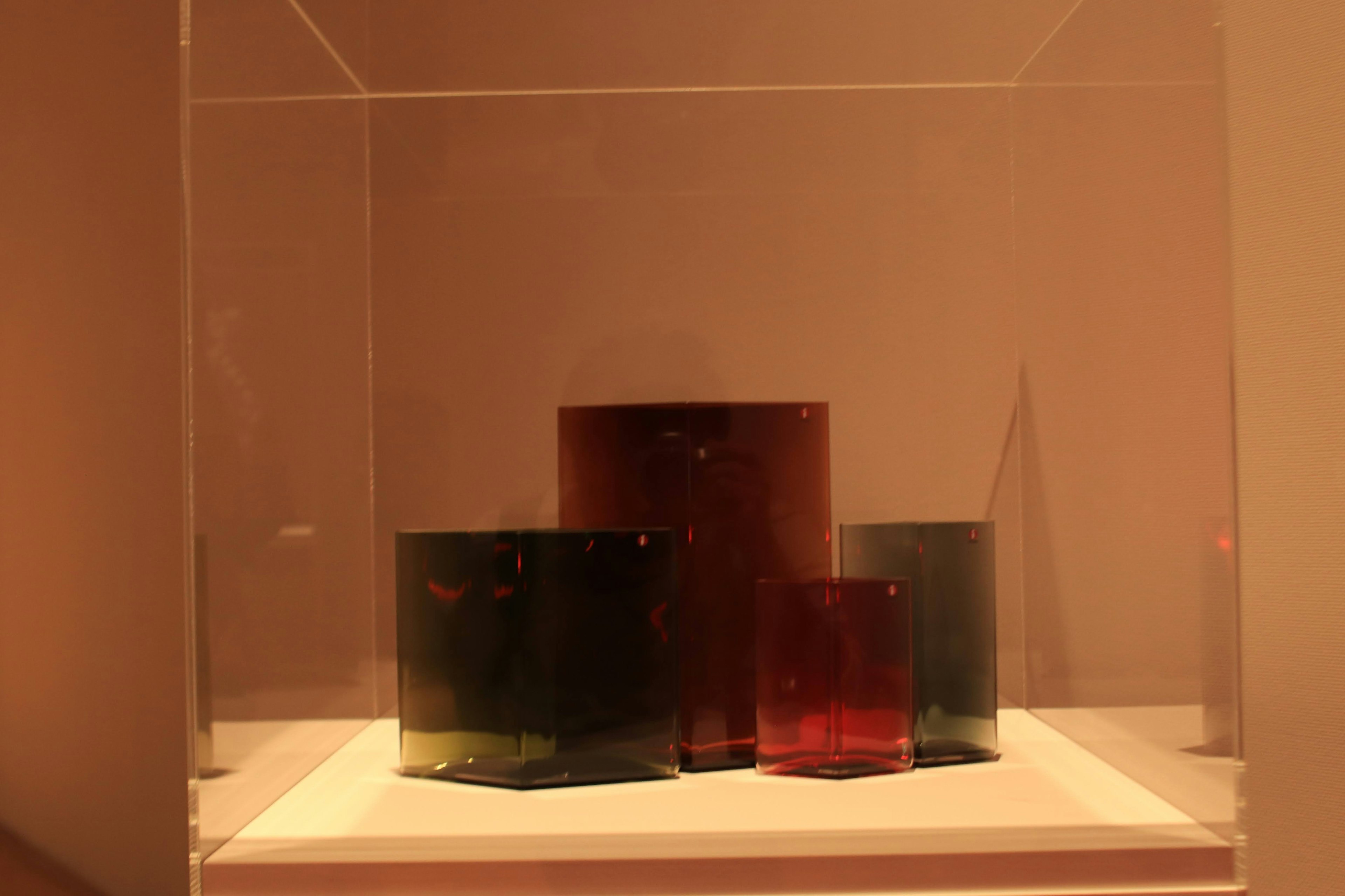 Colorful glass containers displayed as an art piece