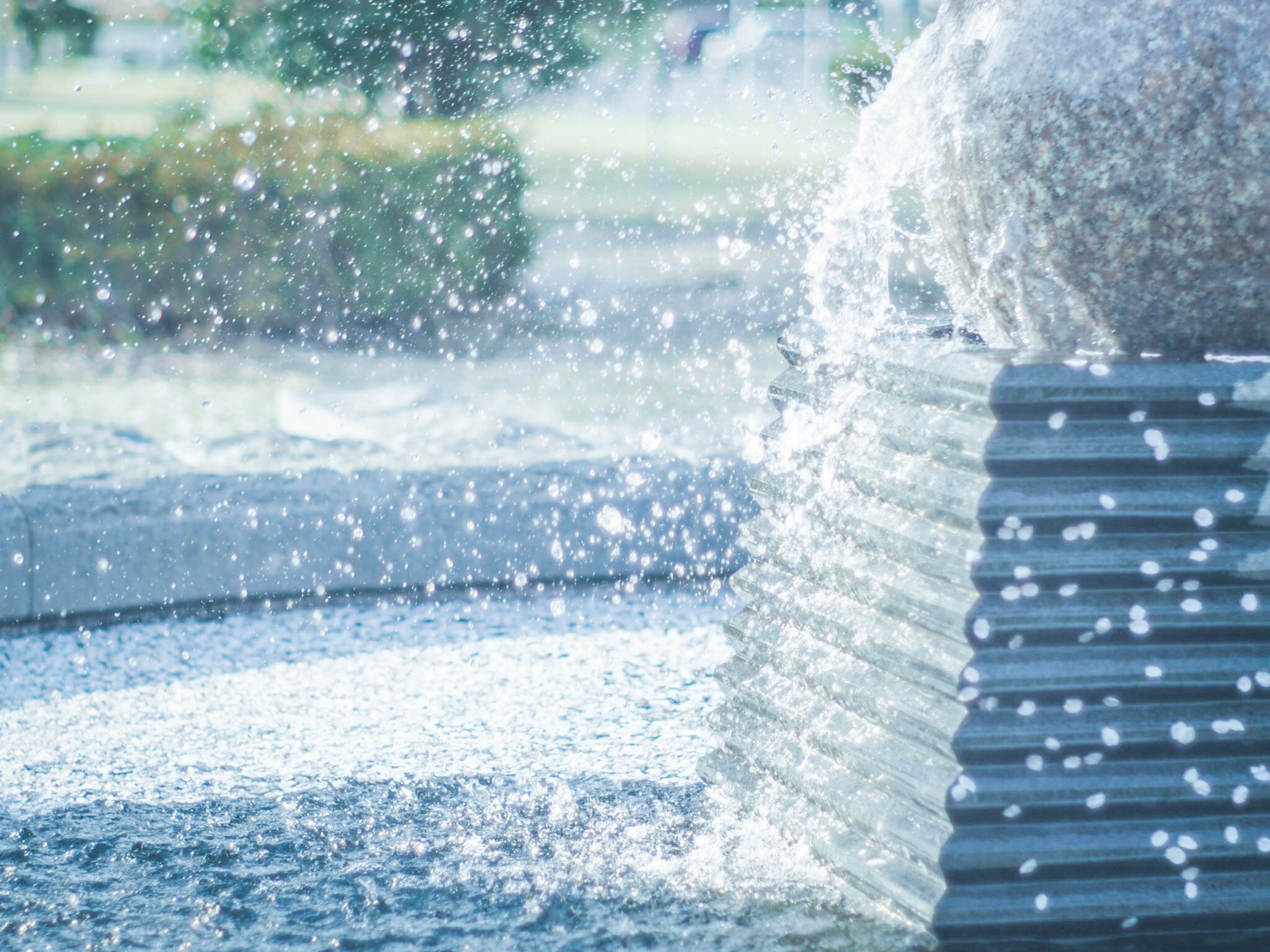 Close-up of a fountain with water splashes near a stone structure