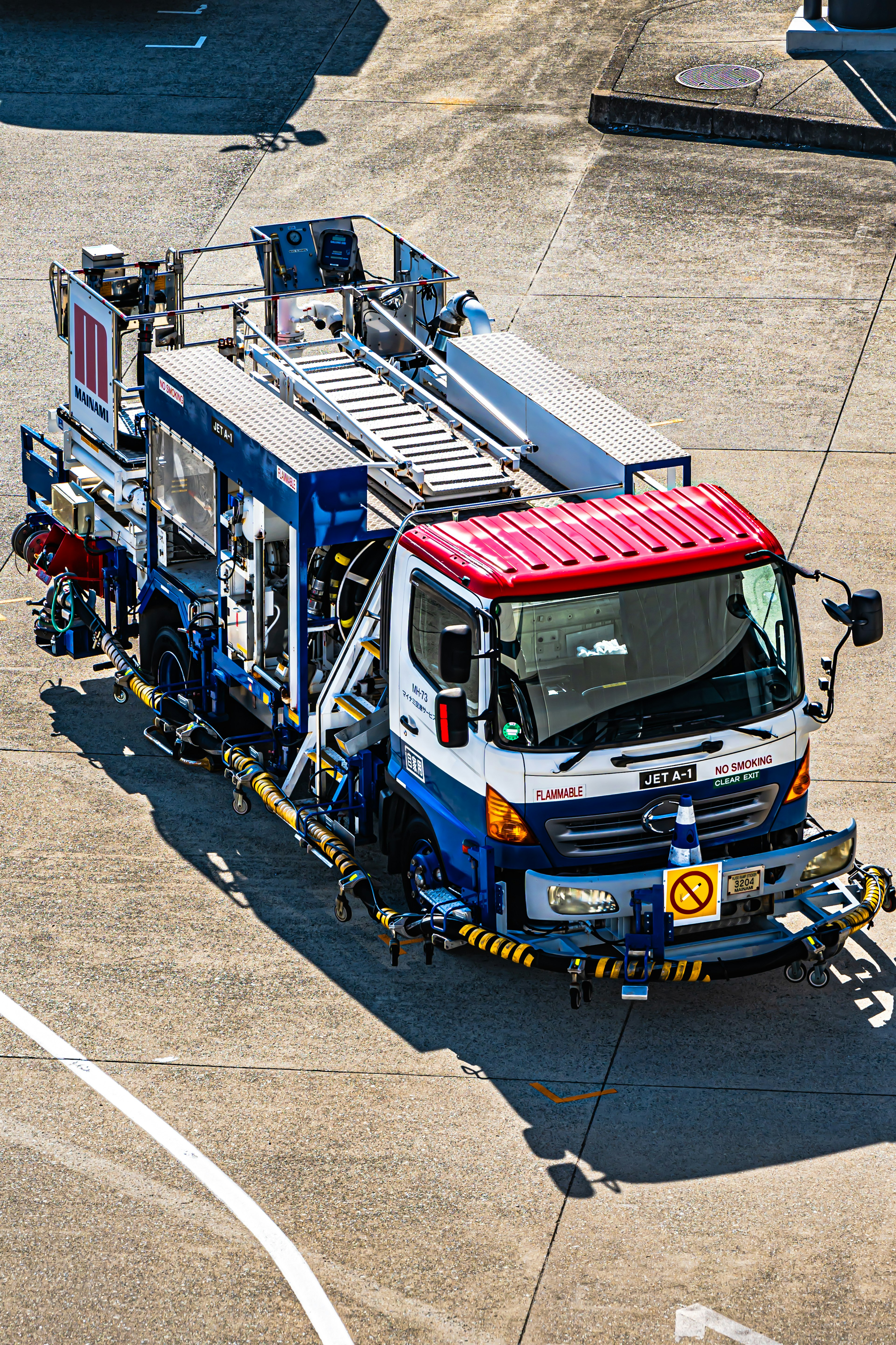 Aircraft service truck with a red roof parked on the runway