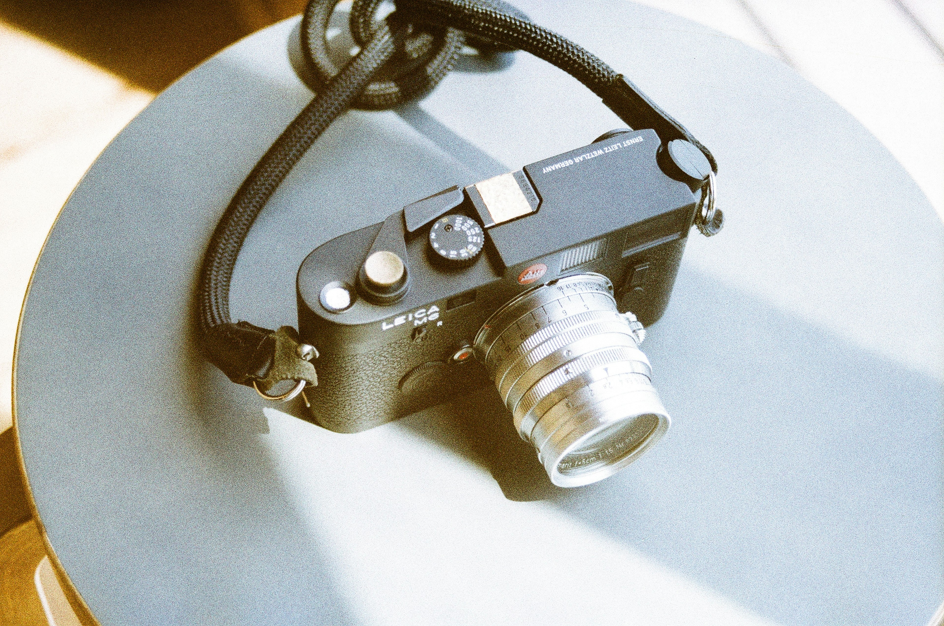 A black camera resting on a round table