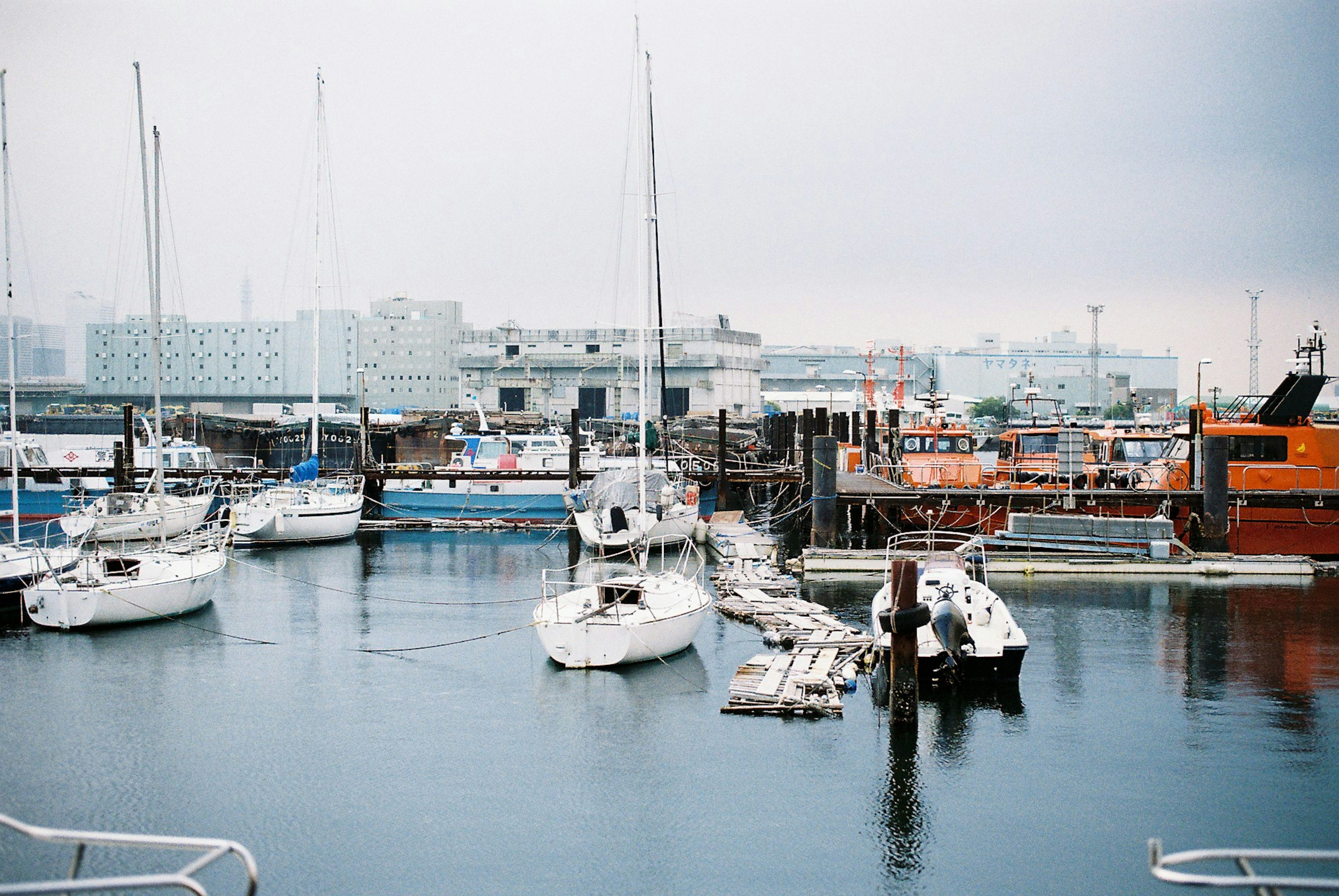 Scena di porto serena con yacht bianchi e barche colorate