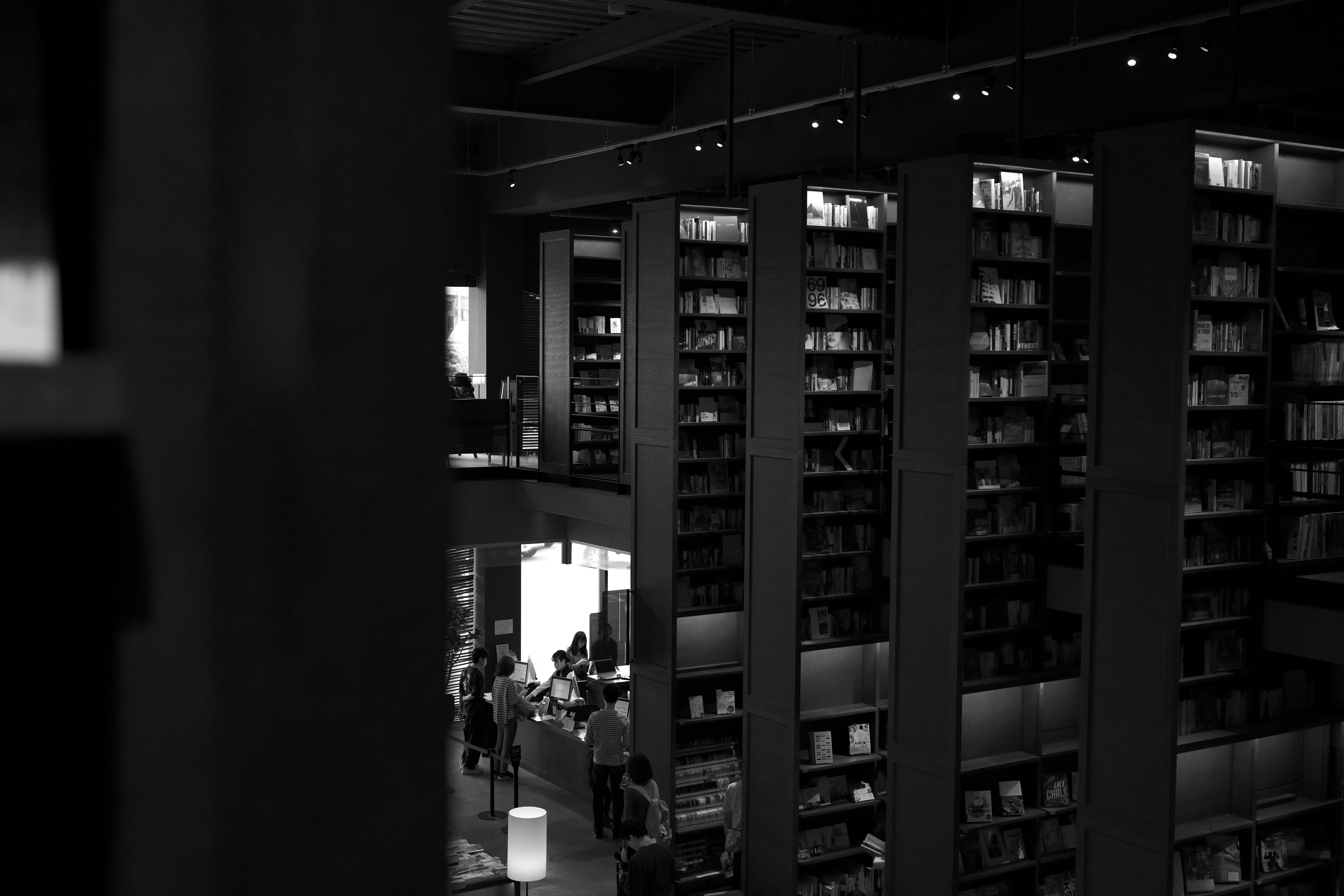 Interno di una libreria con grandi scaffali e persone visibili