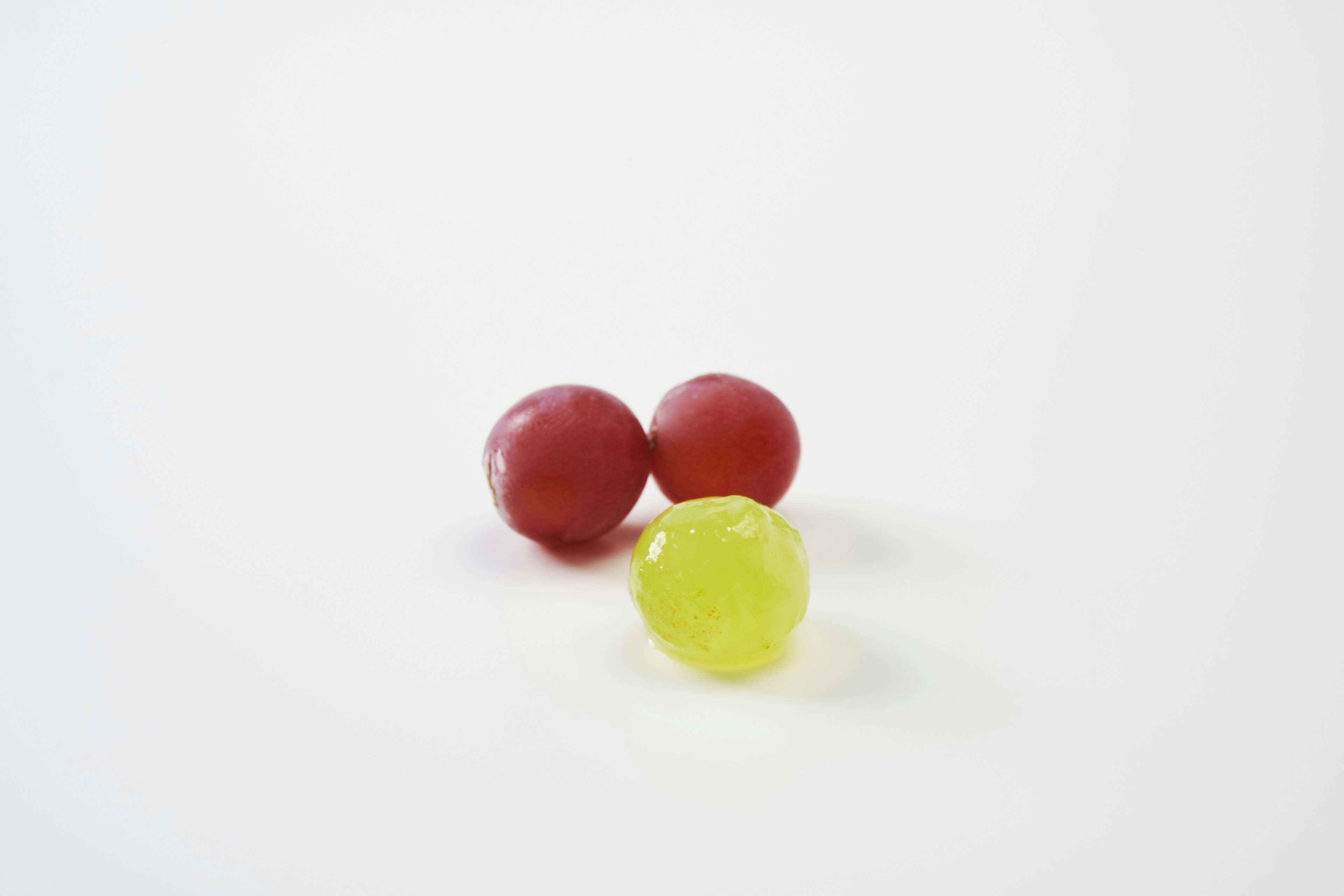 Red and green small balls placed on a white background