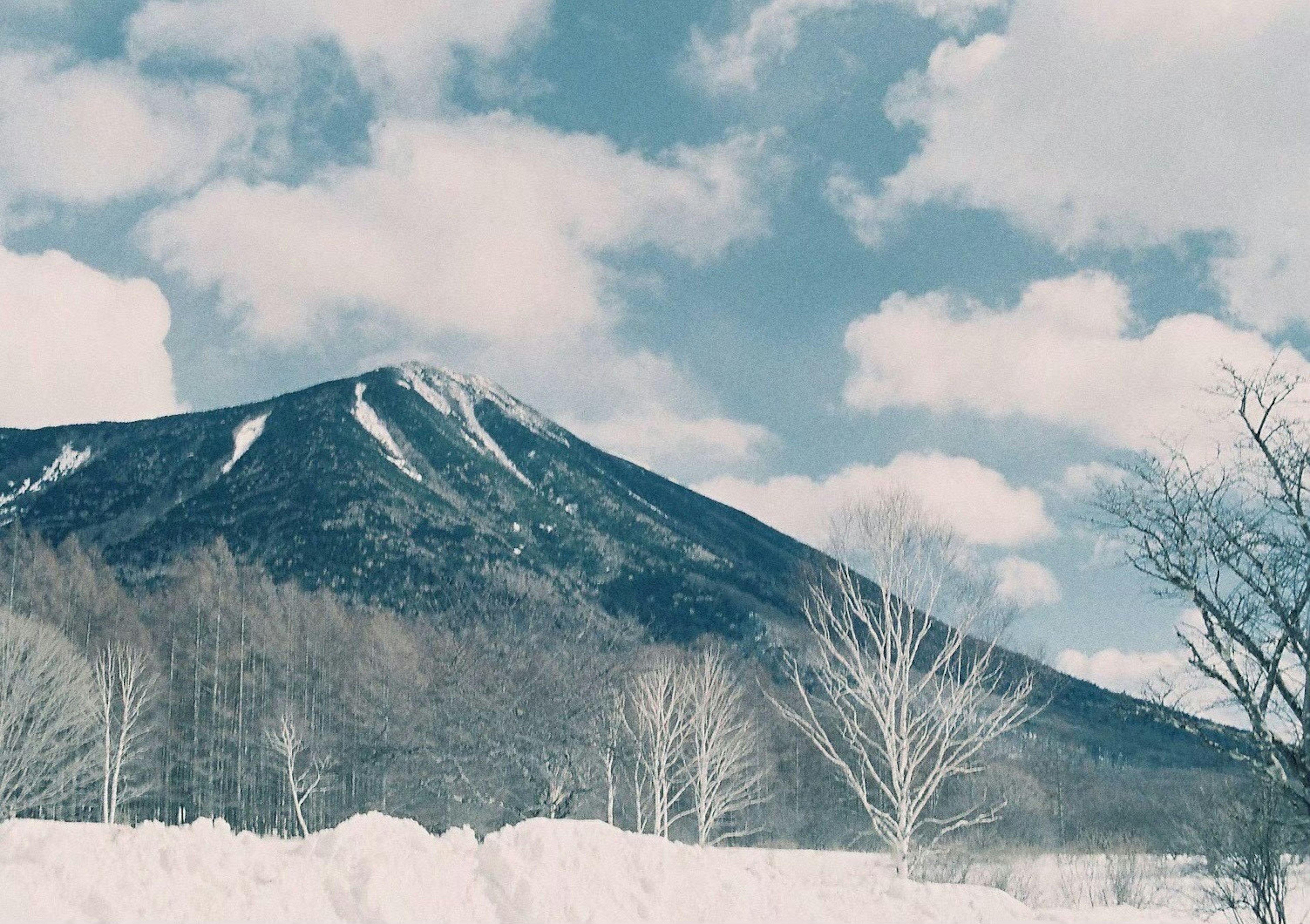 Mountain landscape under a blue sky with white clouds