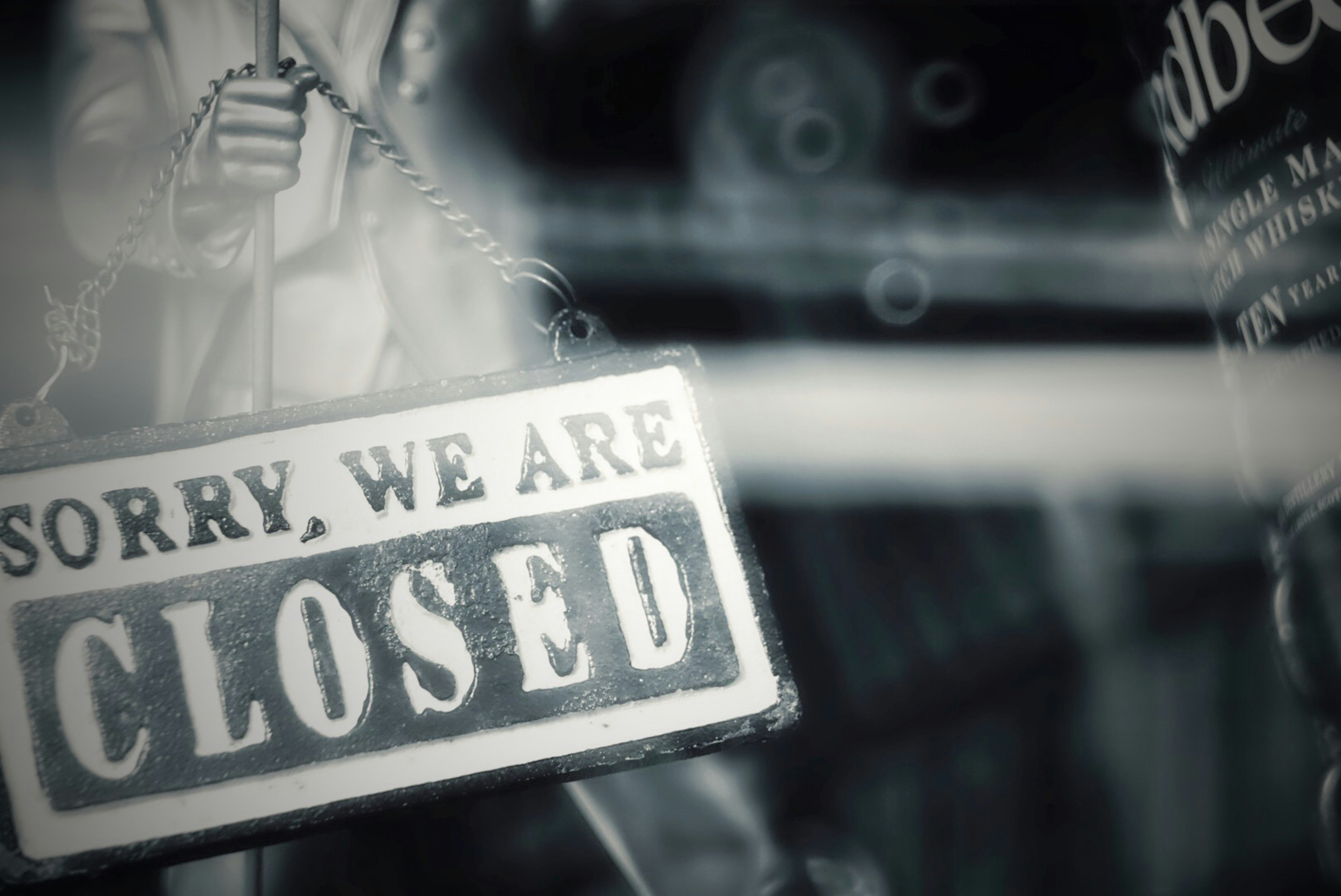 A close-up of a closed sign hanging in a store window