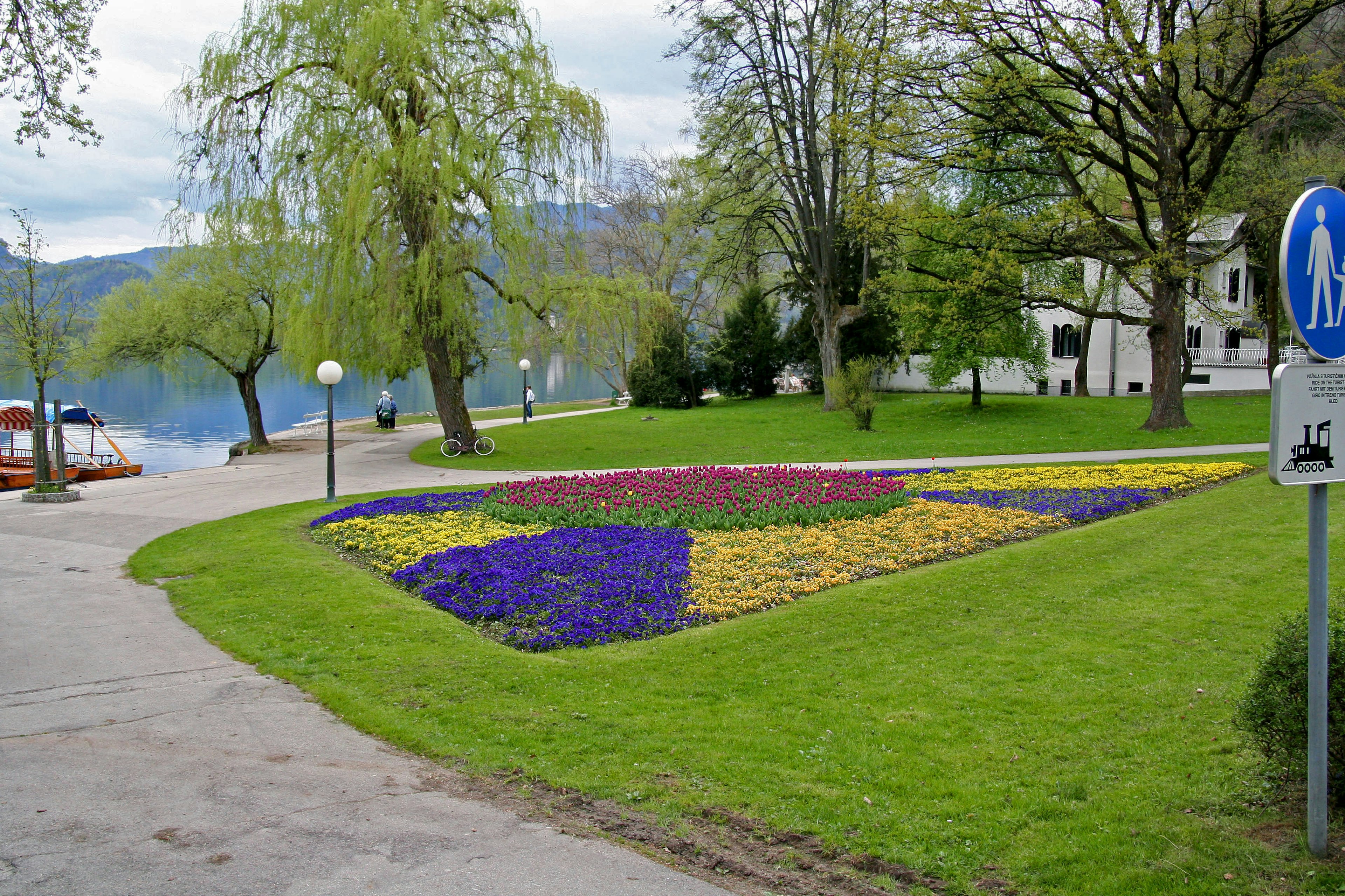 Scenic park view with a colorful flower bed and lake