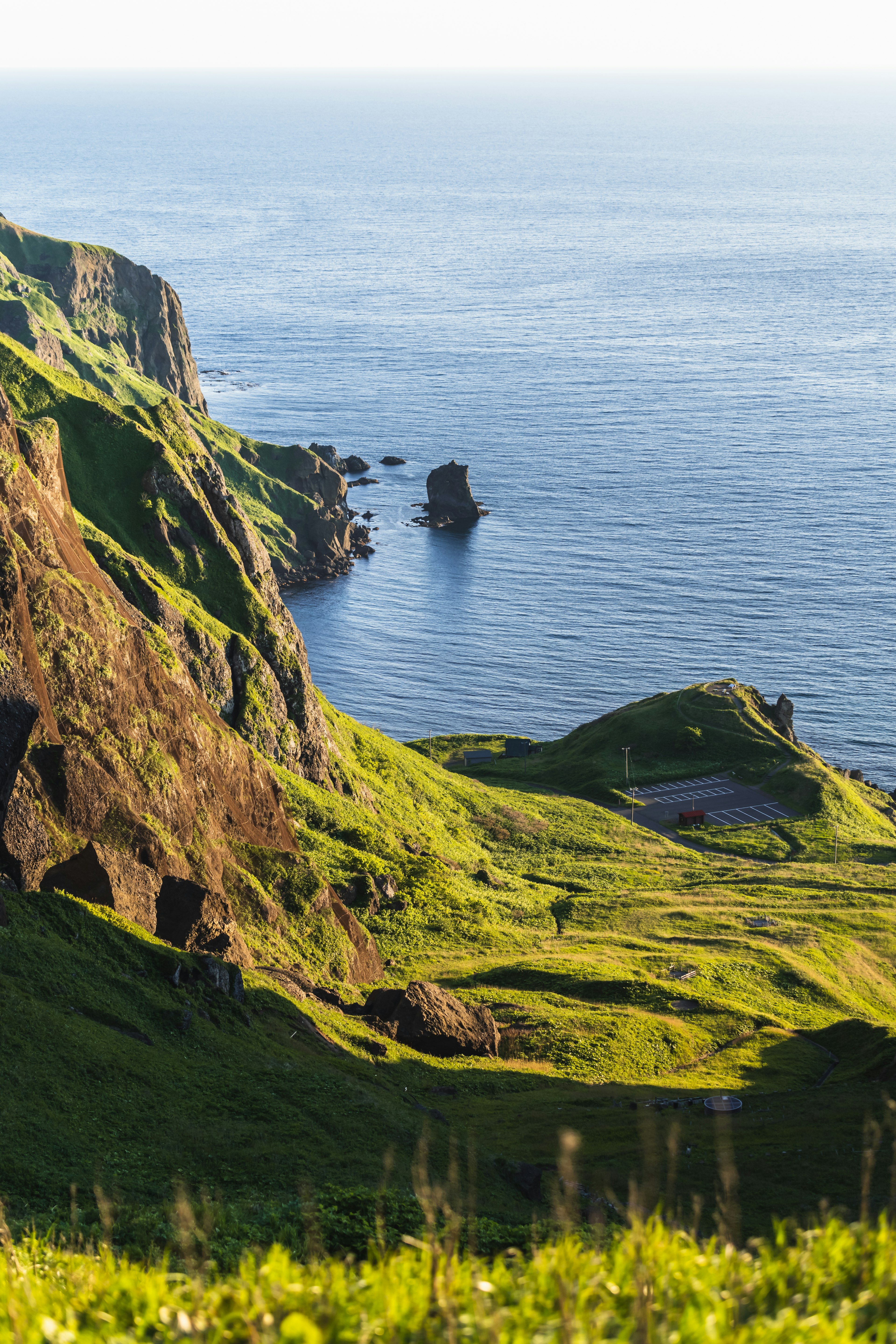 Stunning view of green hills and the ocean