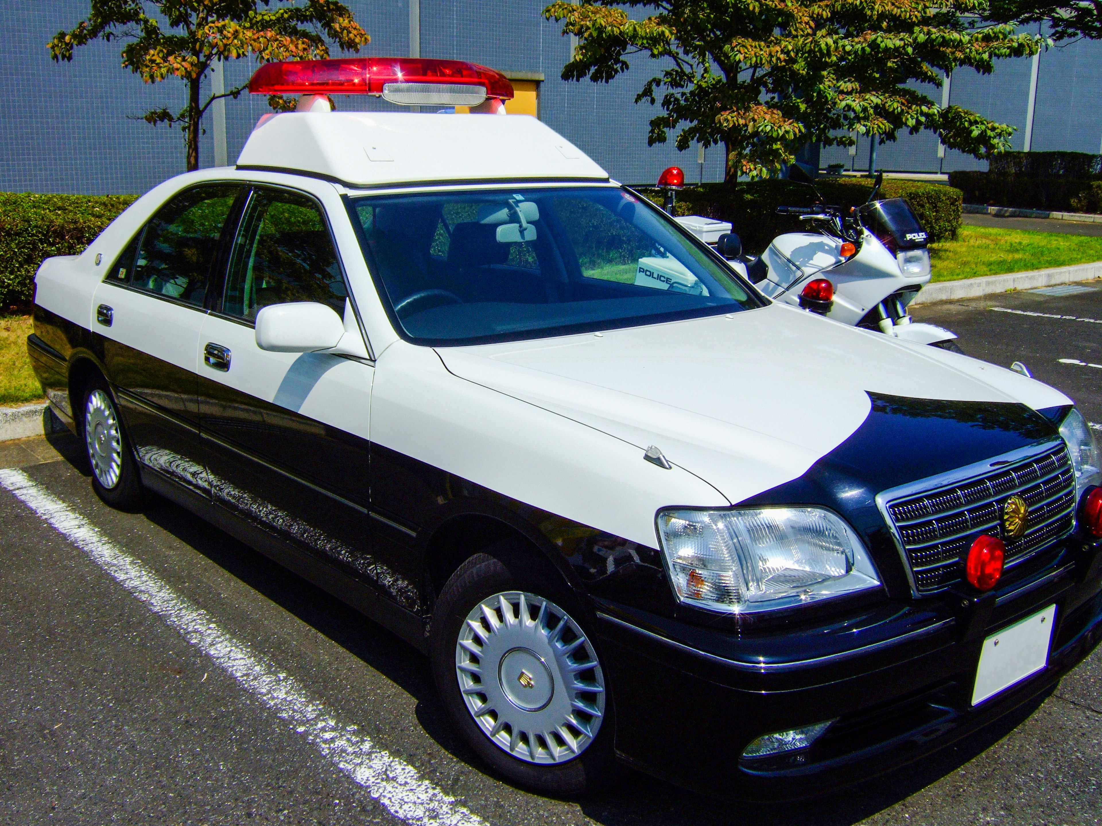 Black and white police car parked in a lot