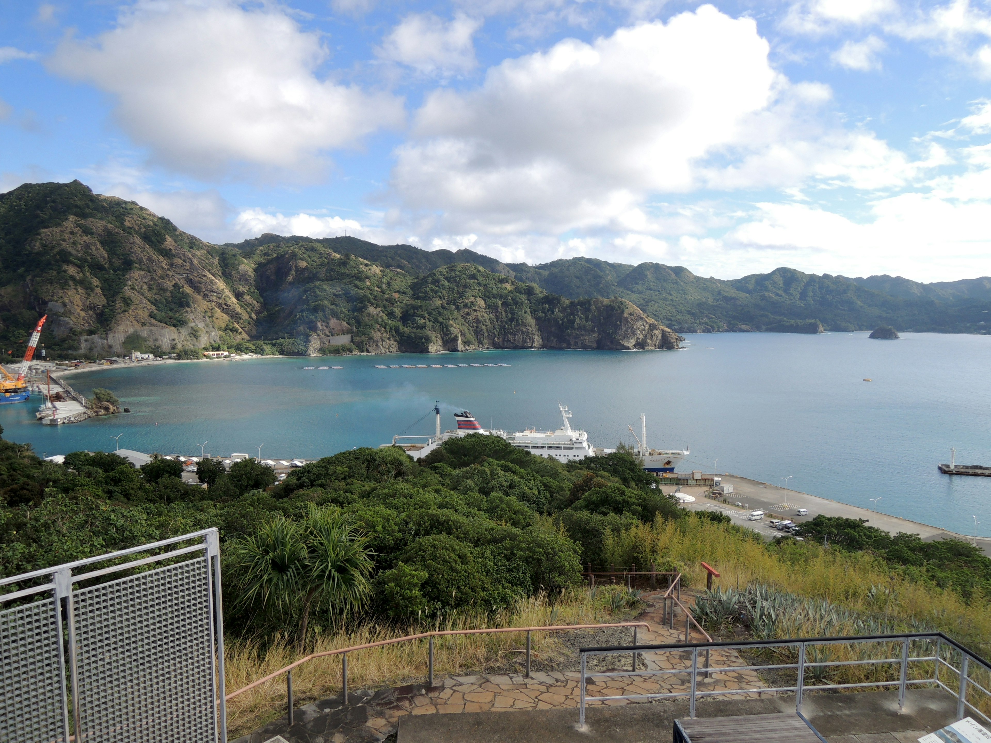 Scenic view of a bay surrounded by mountains with boats docked at a resort area