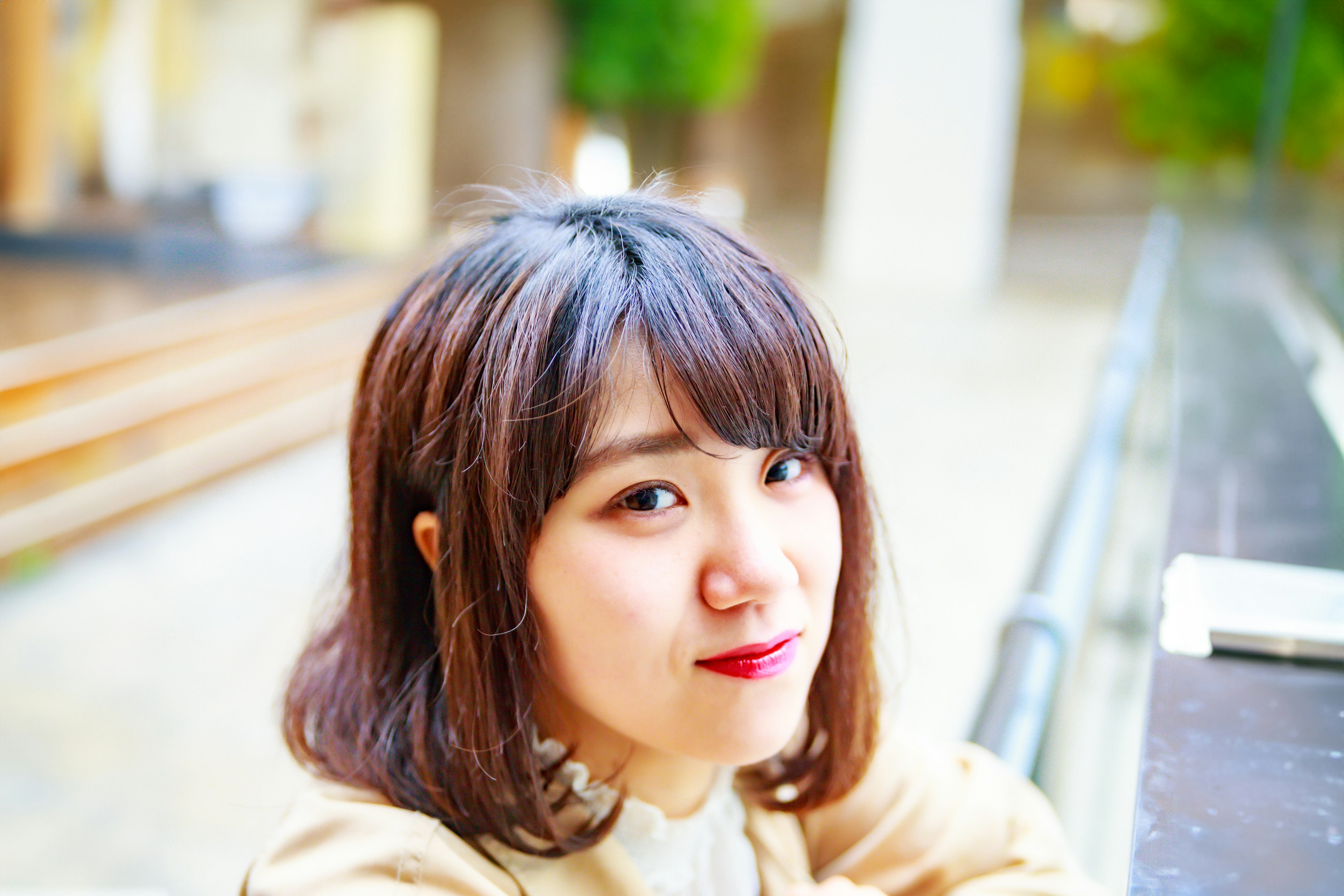 Young woman smiling with a bright background