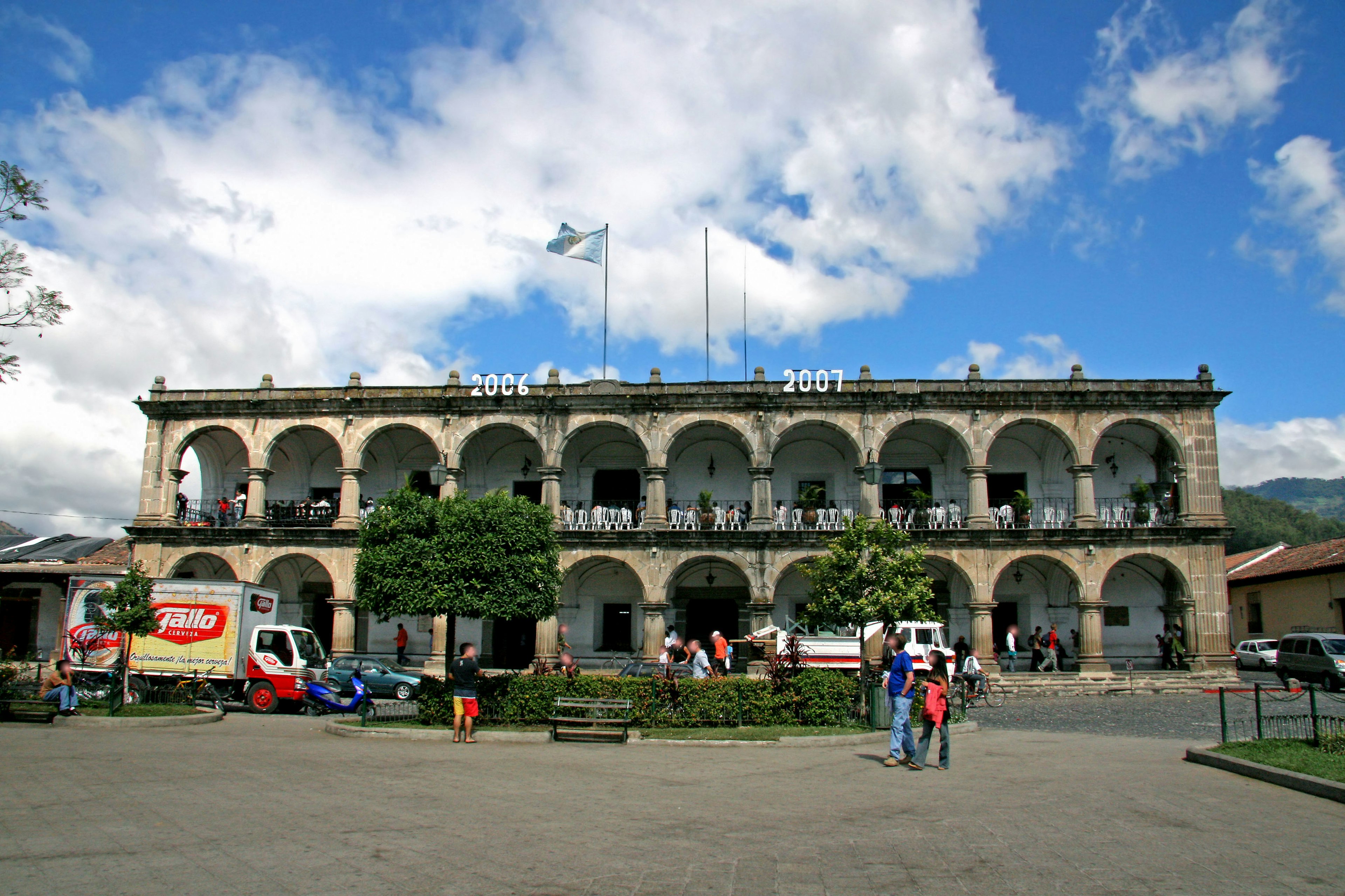 Historic building exterior featuring arched windows and green trees