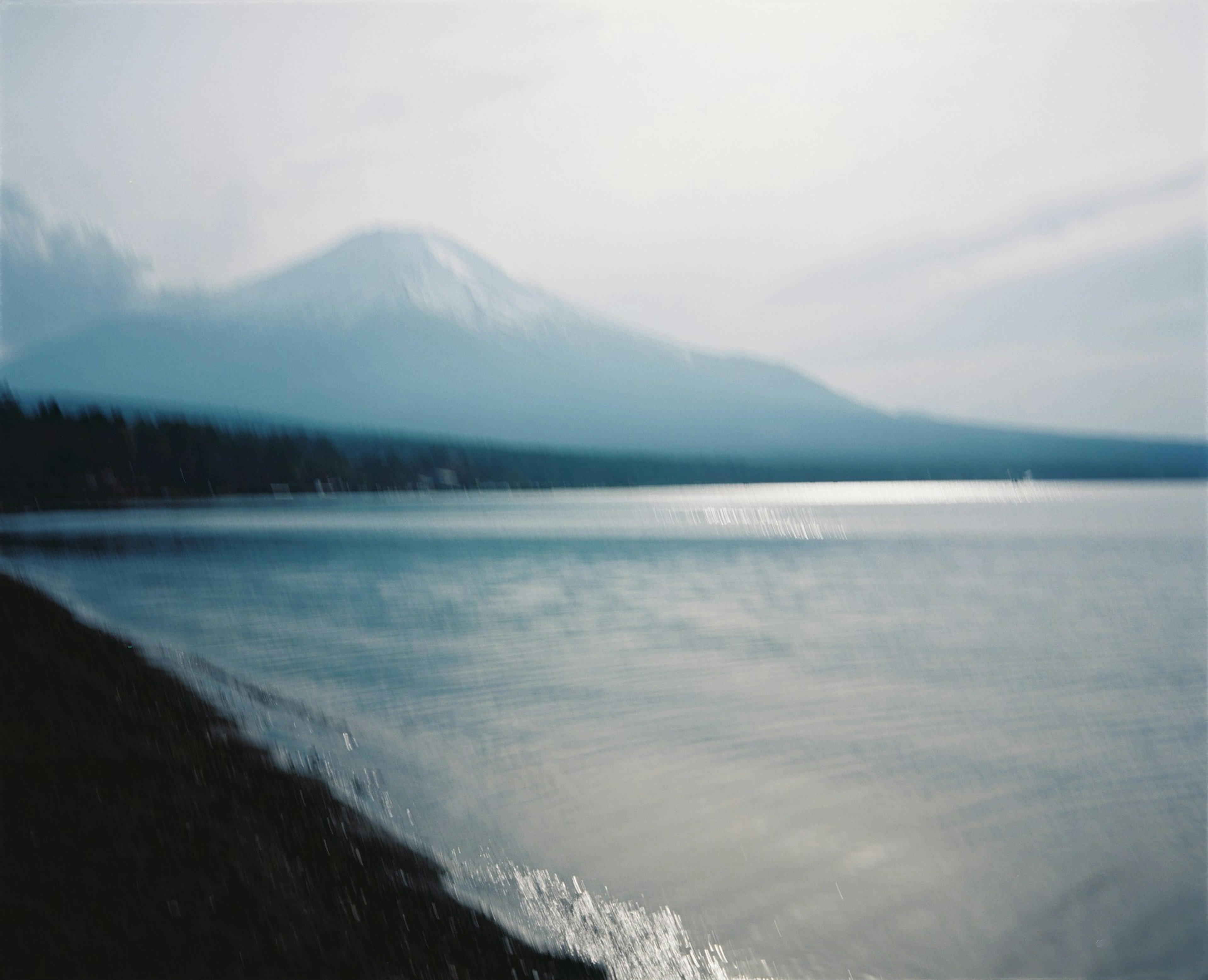 Serene scene of a blue lake with Mount Fuji in the background