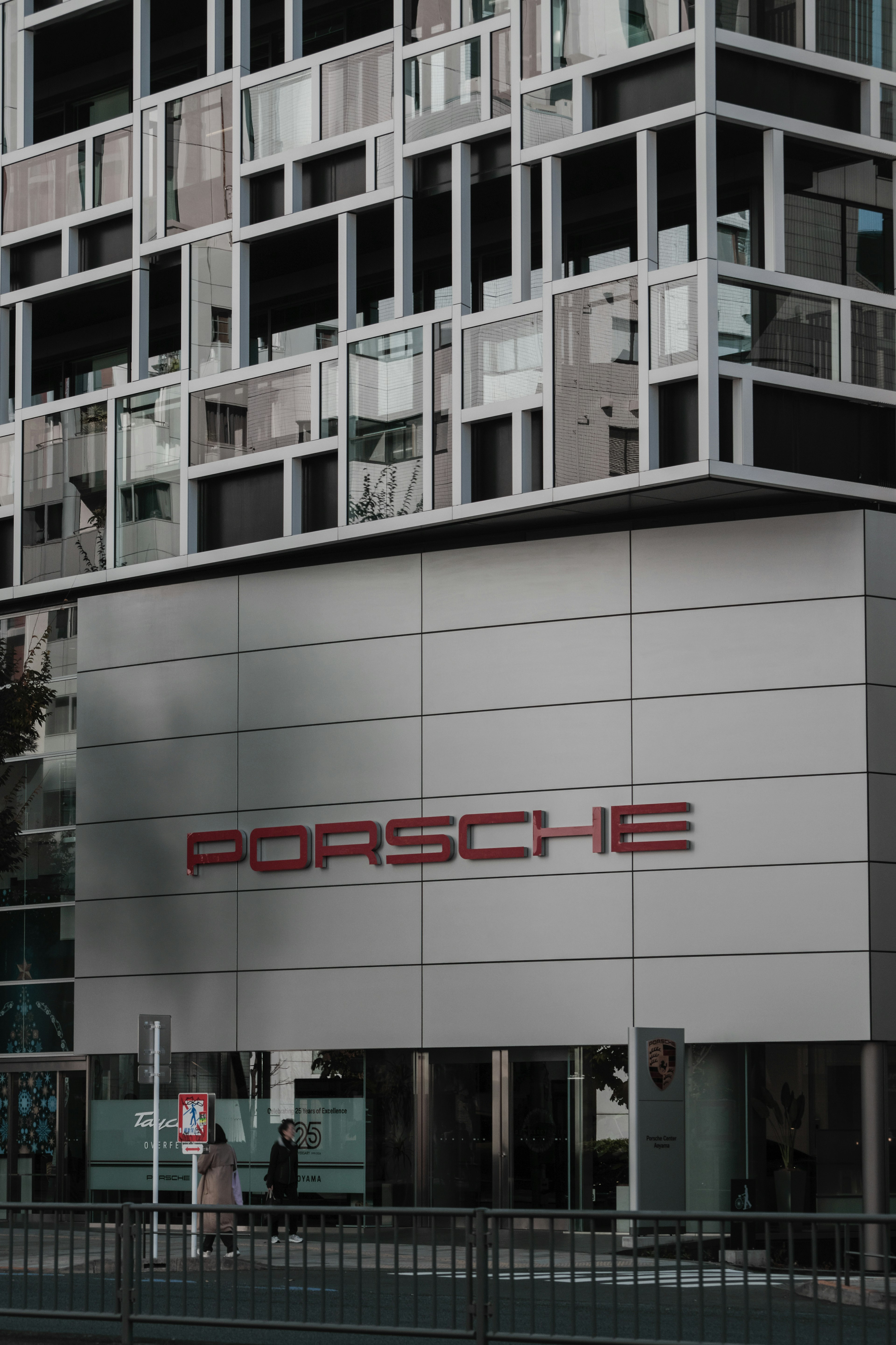 Porsche dealership in front of a modern building