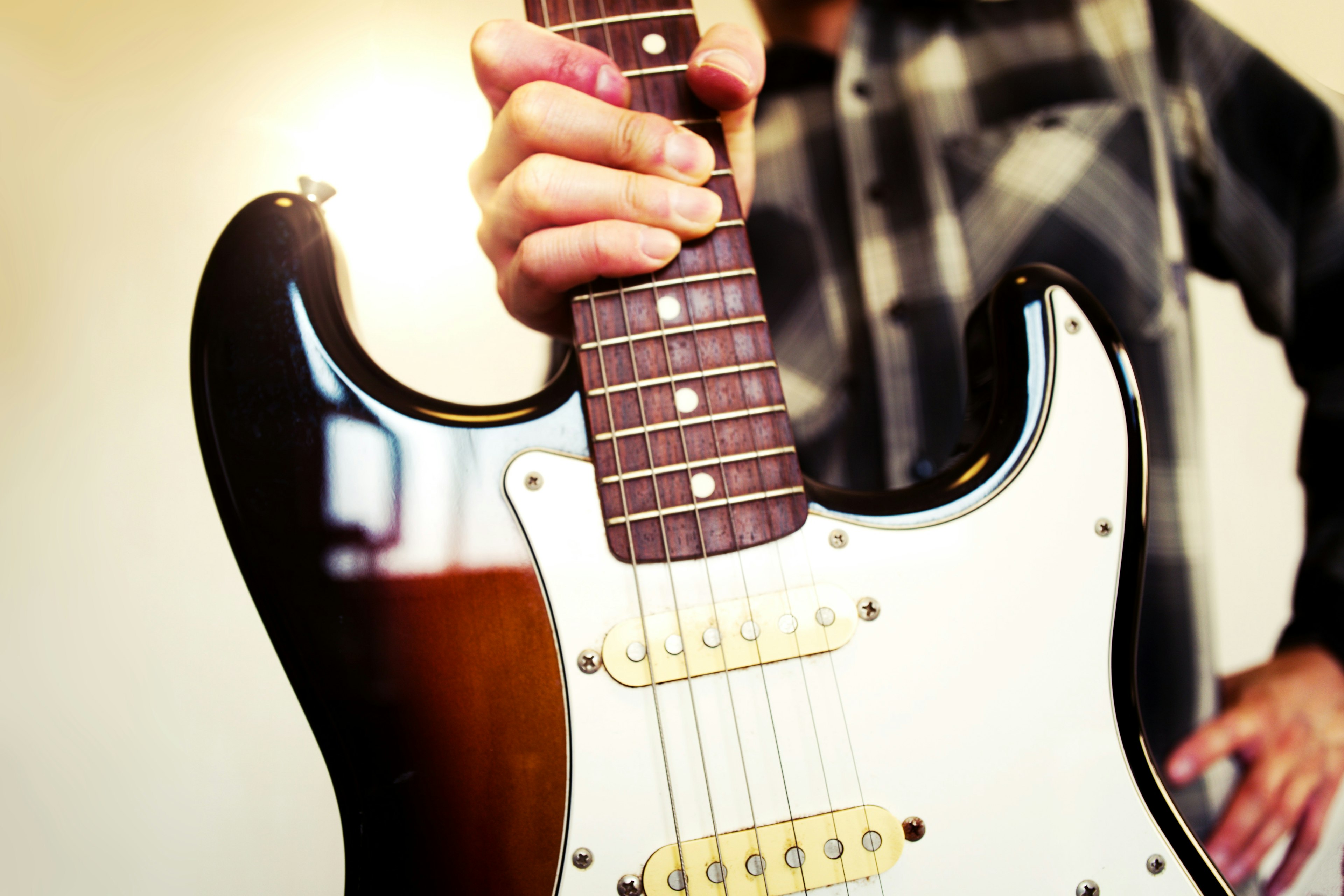 Nahaufnahme einer Person, die eine Gitarre hält