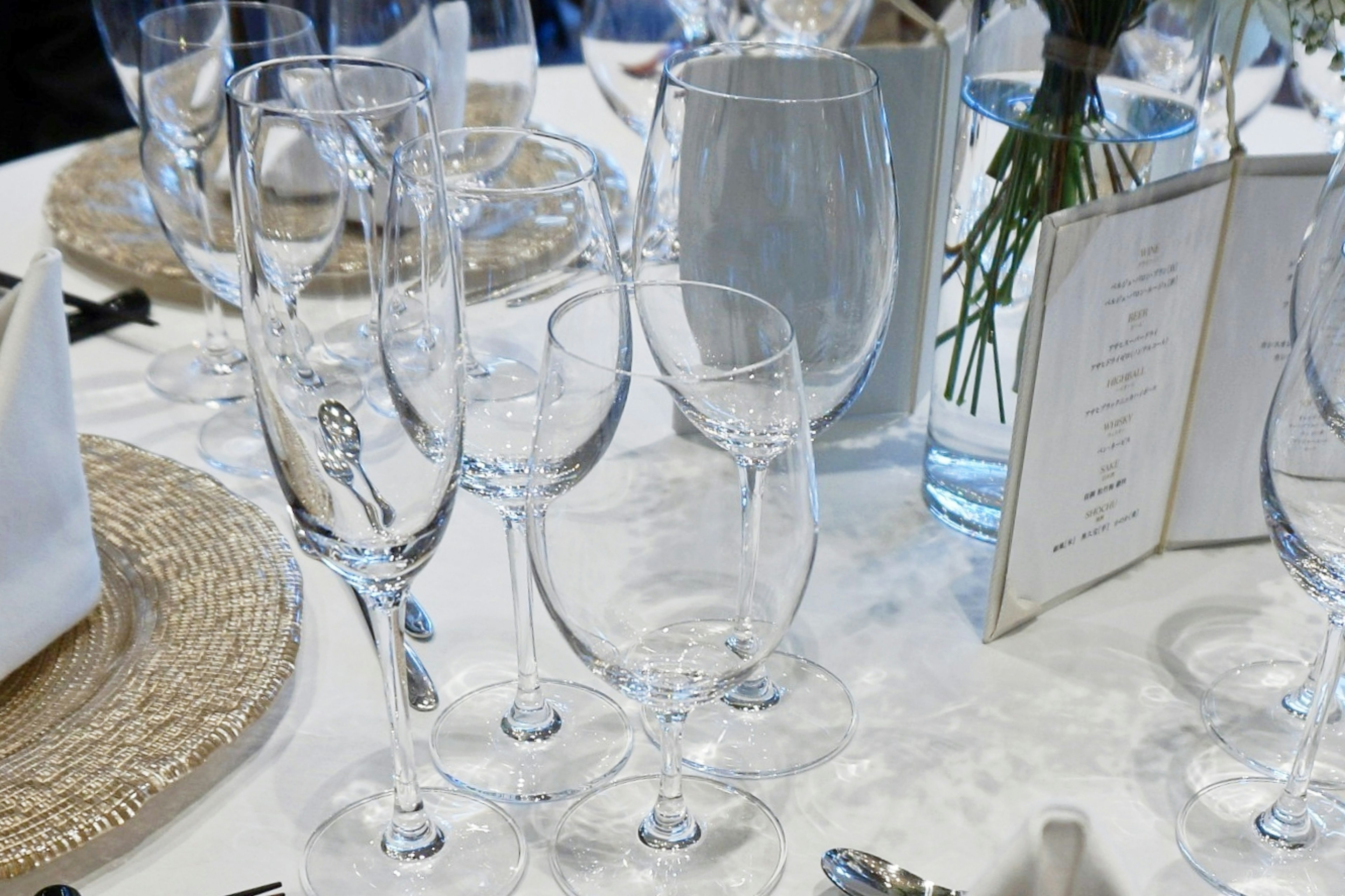 Elegant table setting with various glasses and a water pitcher