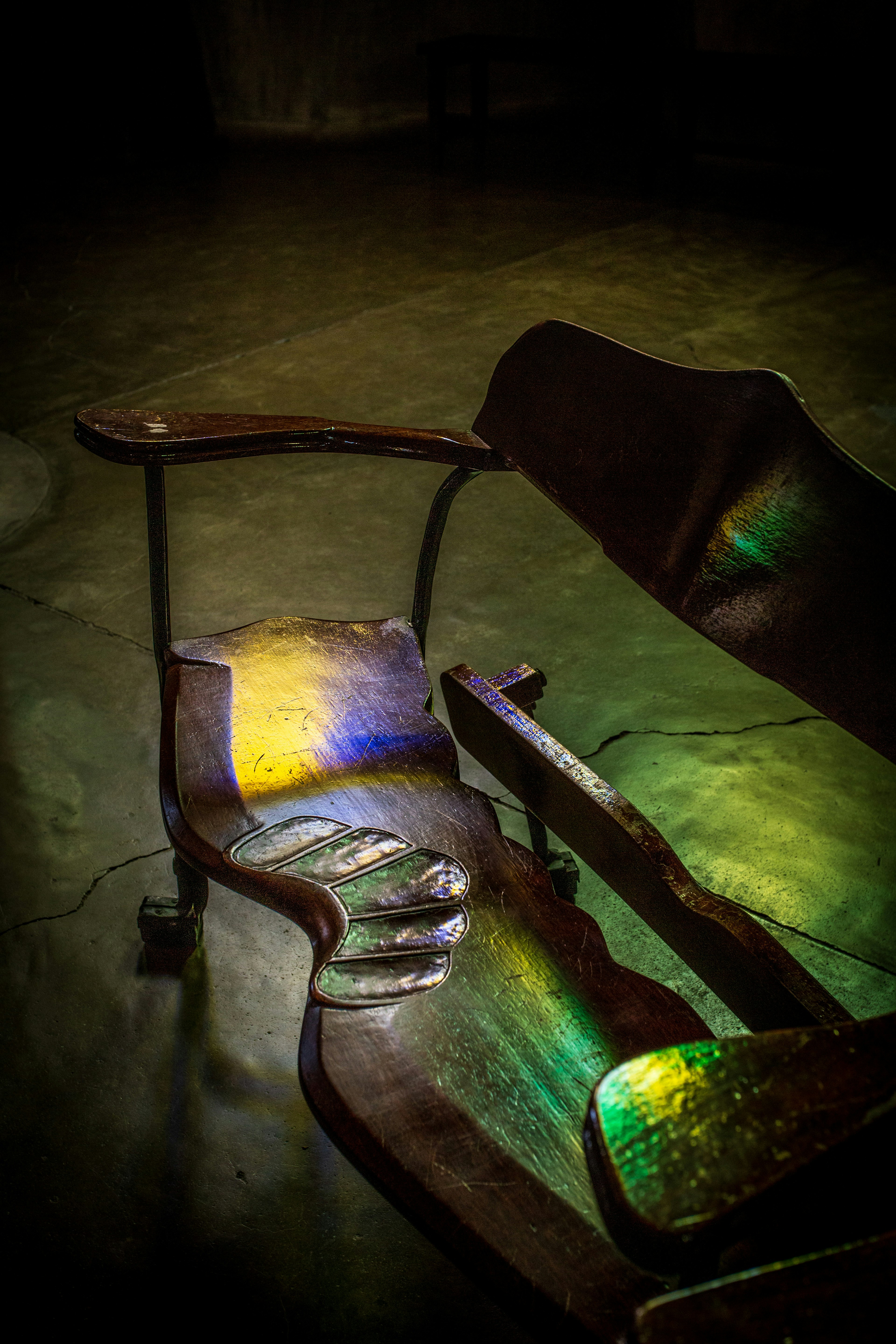 A section of an old chair with colorful light reflections