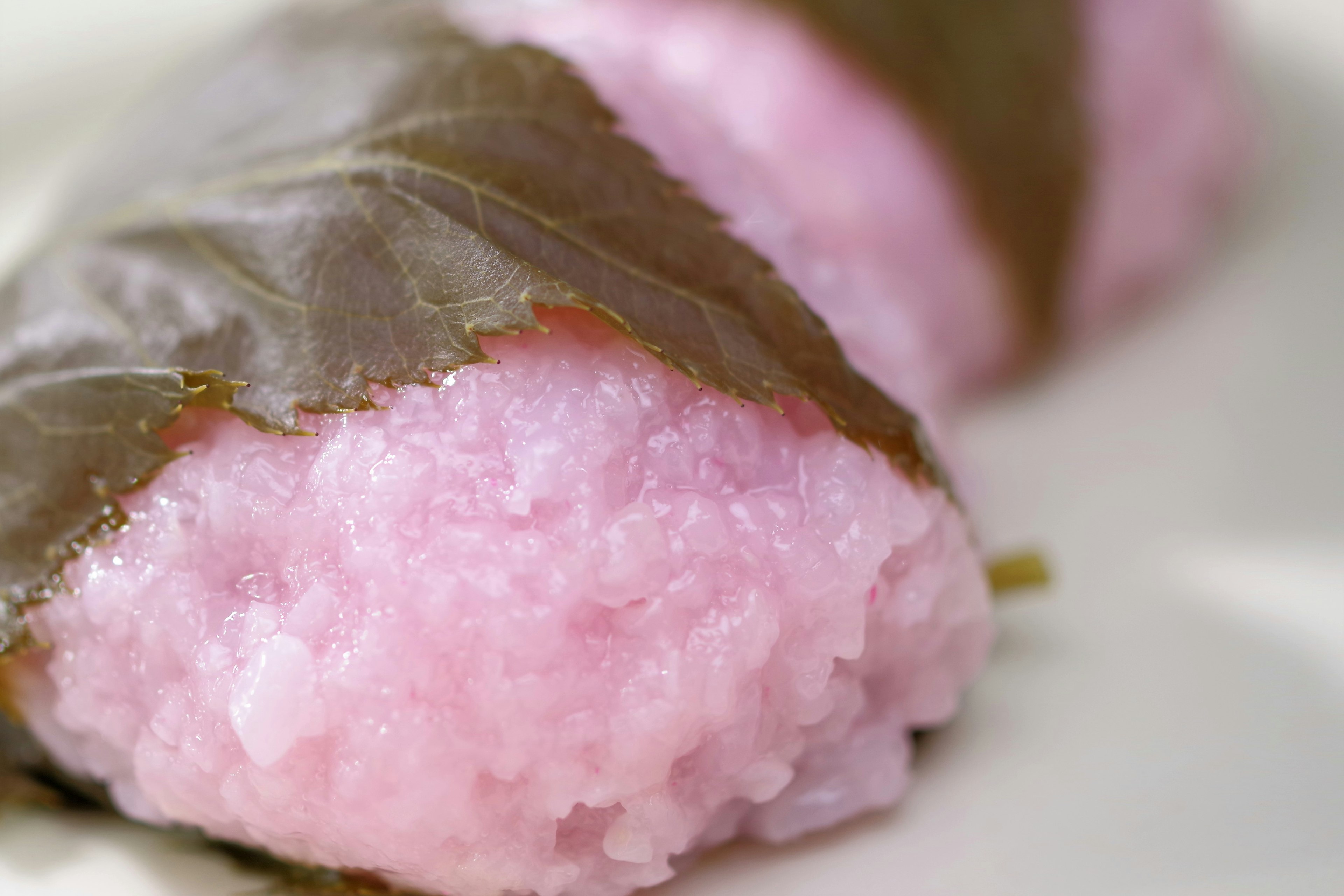 Pink rice cake wrapped in cherry leaves