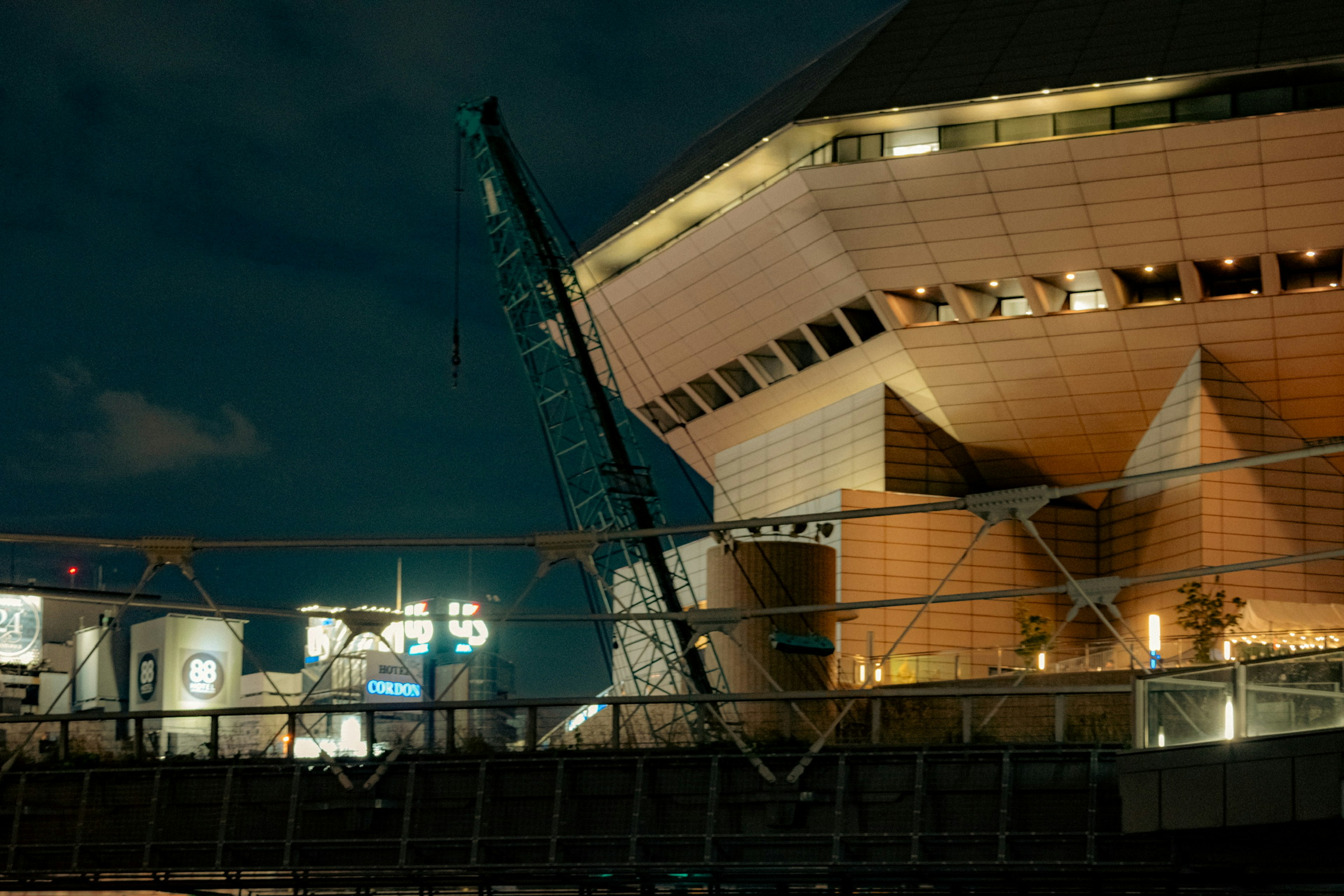 Modern building and crane in a night scene