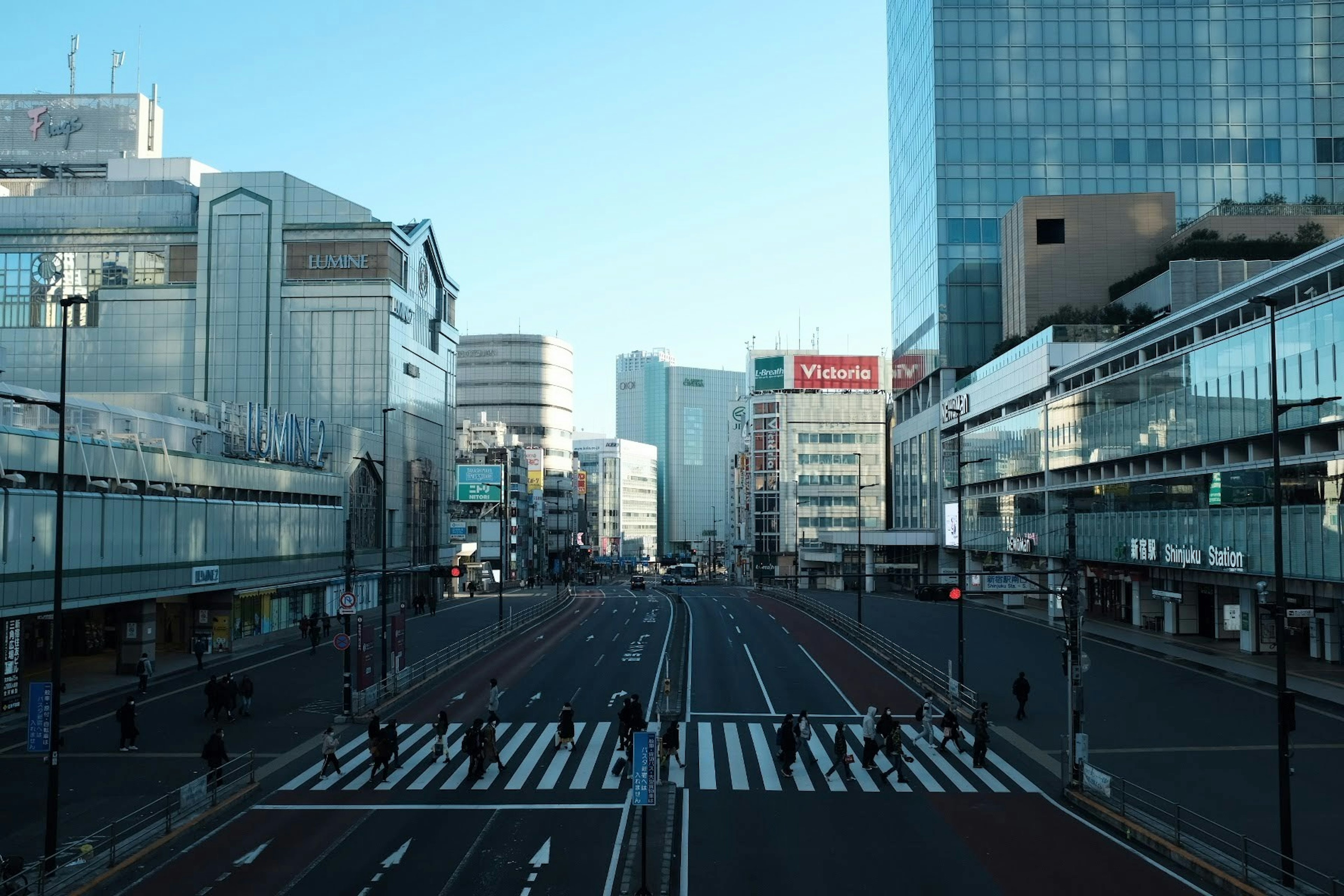 Deserted urban landscape wide street and crosswalk buildings lining the sides