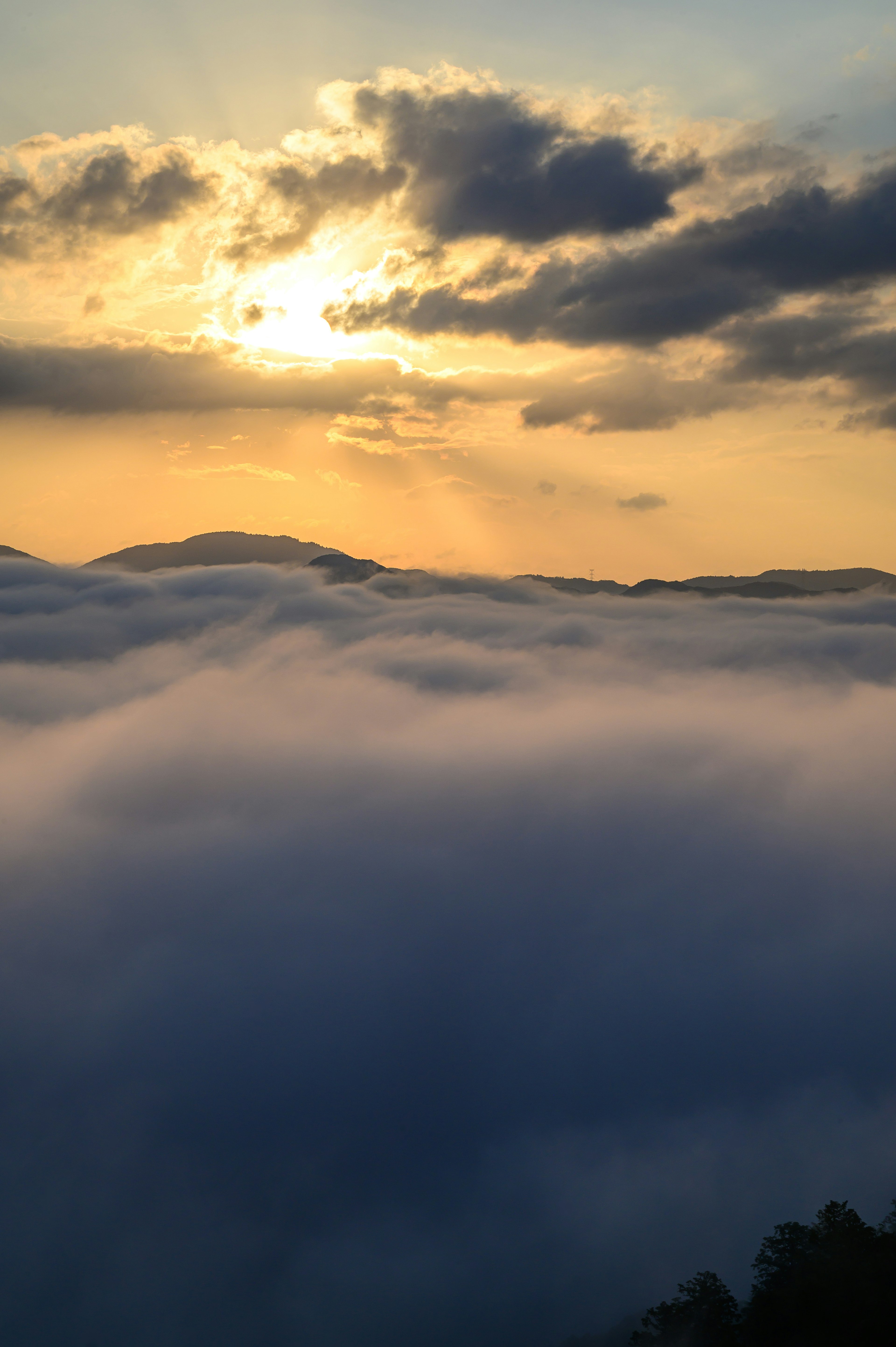 Sunset over a sea of clouds with blue sky