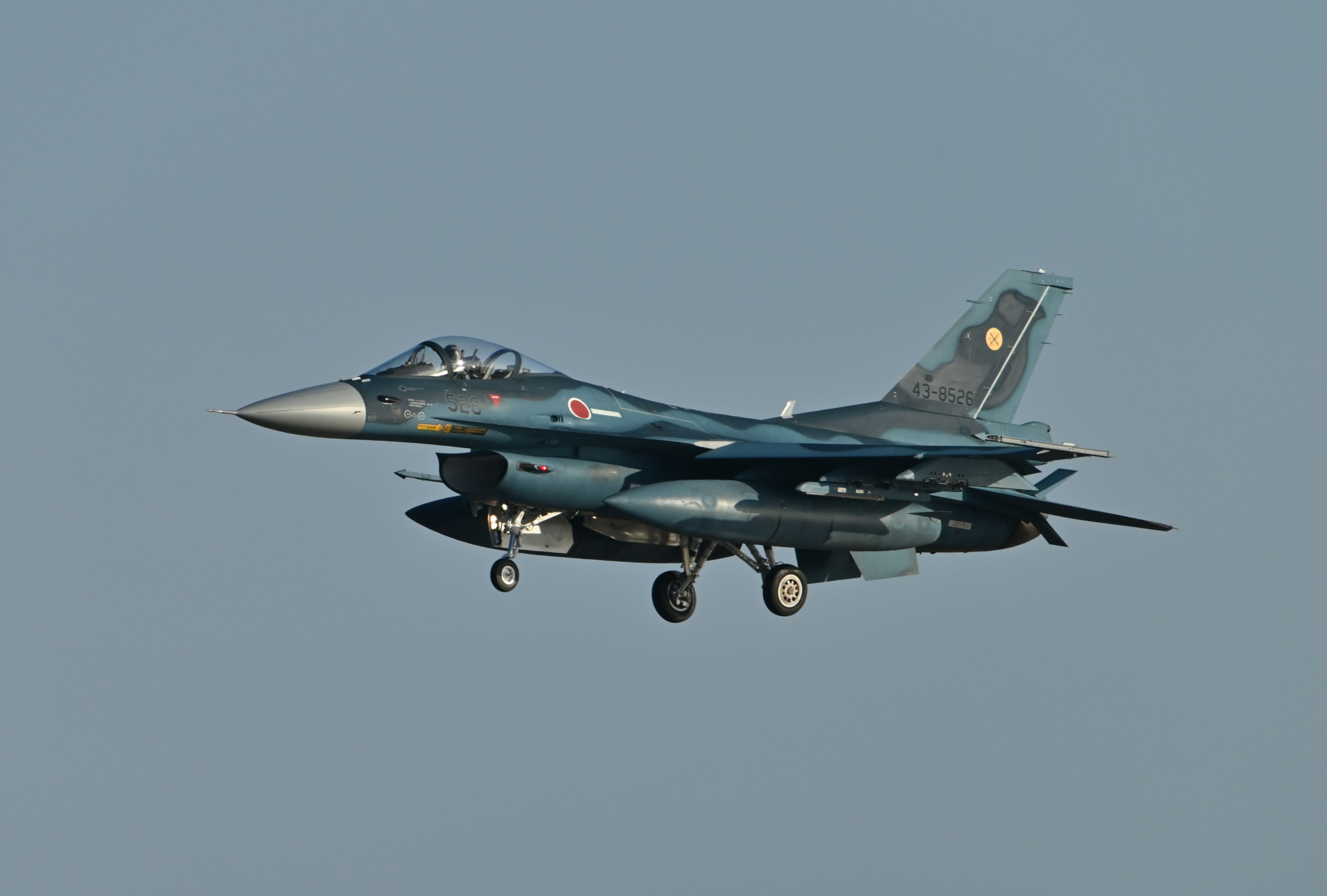 Image of a fighter jet flying with a clear blue sky background