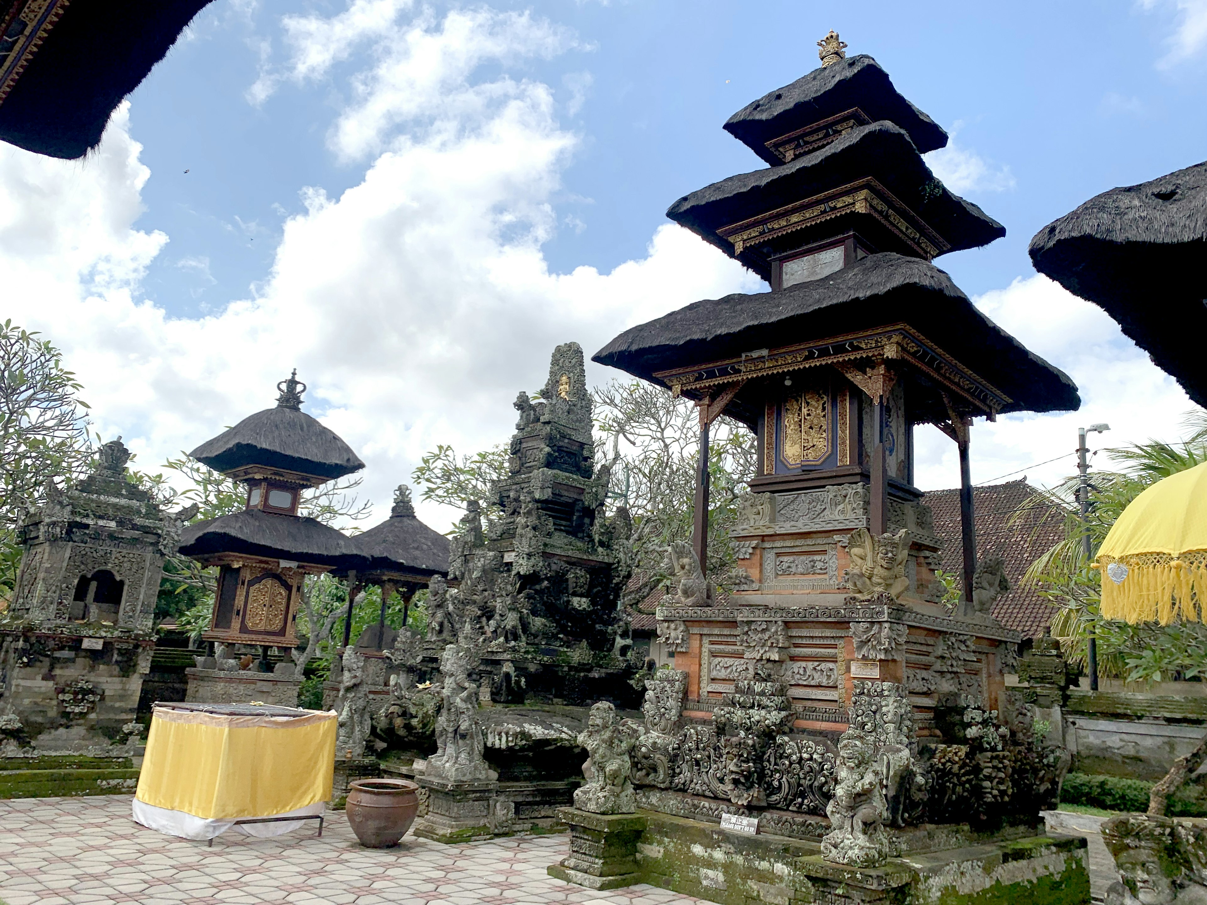 Scenic view of a Balinese temple featuring traditional towers and stone carvings