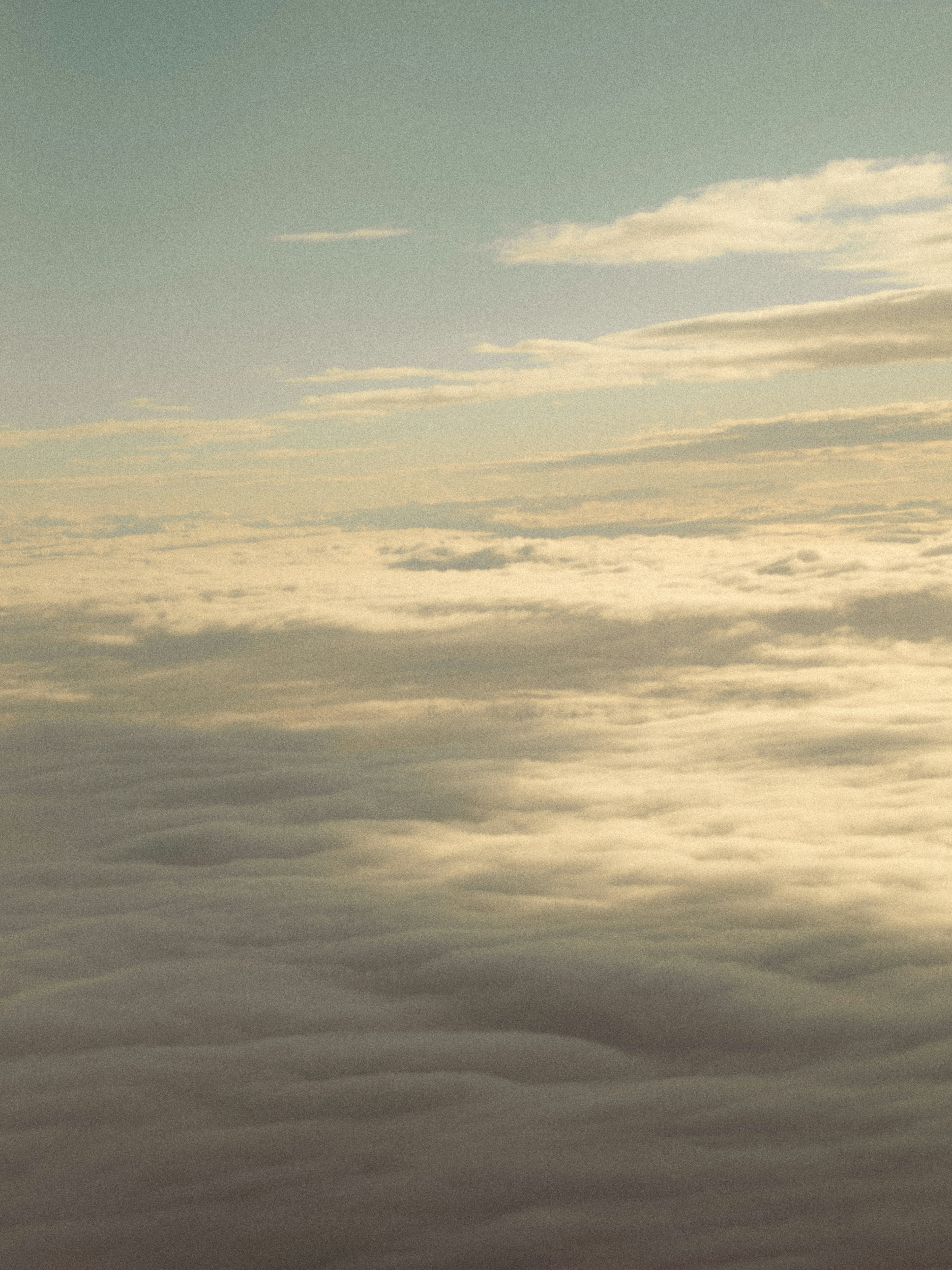 Sky view covered with clouds in soft blue and cream tones