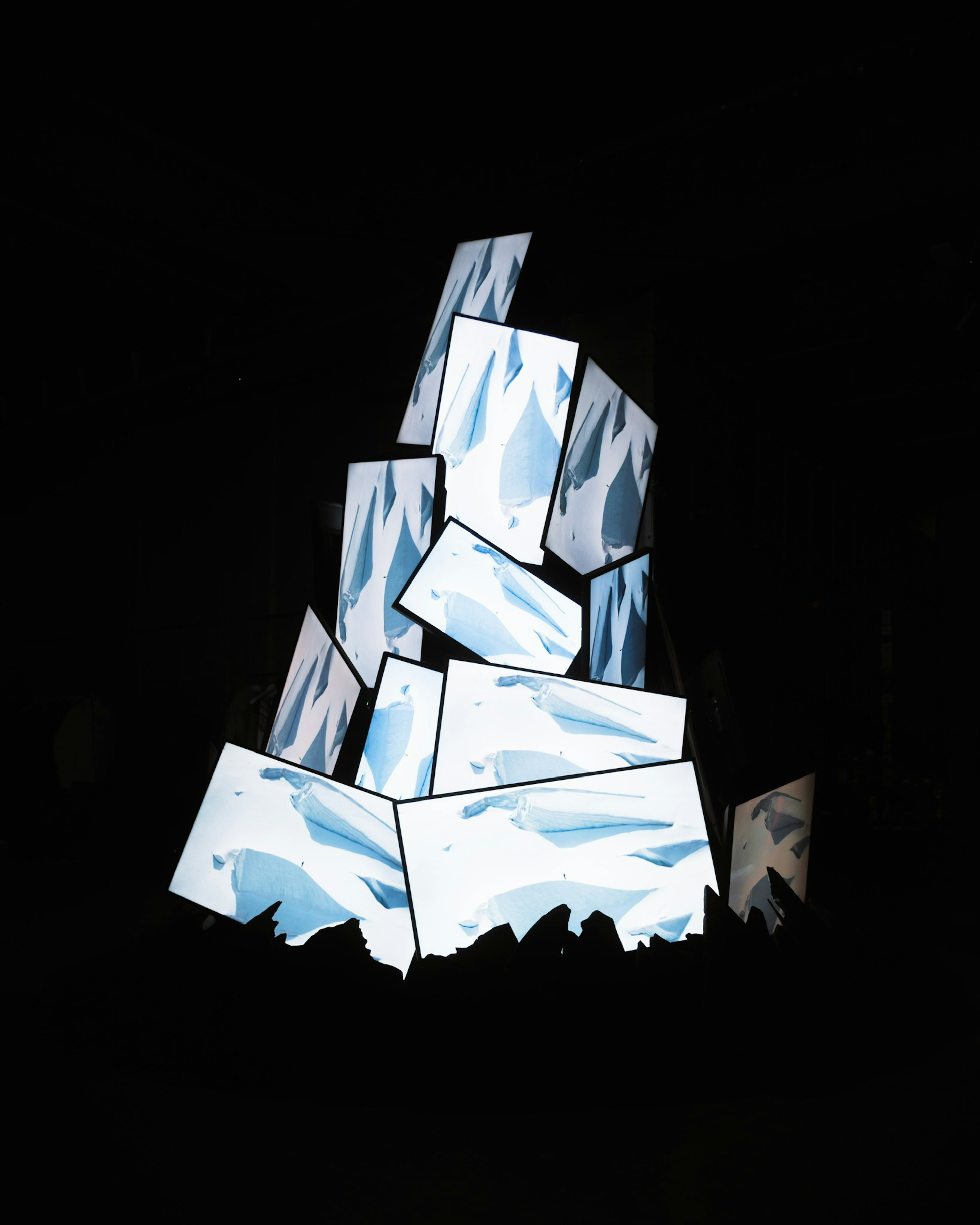 Artistic representation of stacked ice blocks on a black background