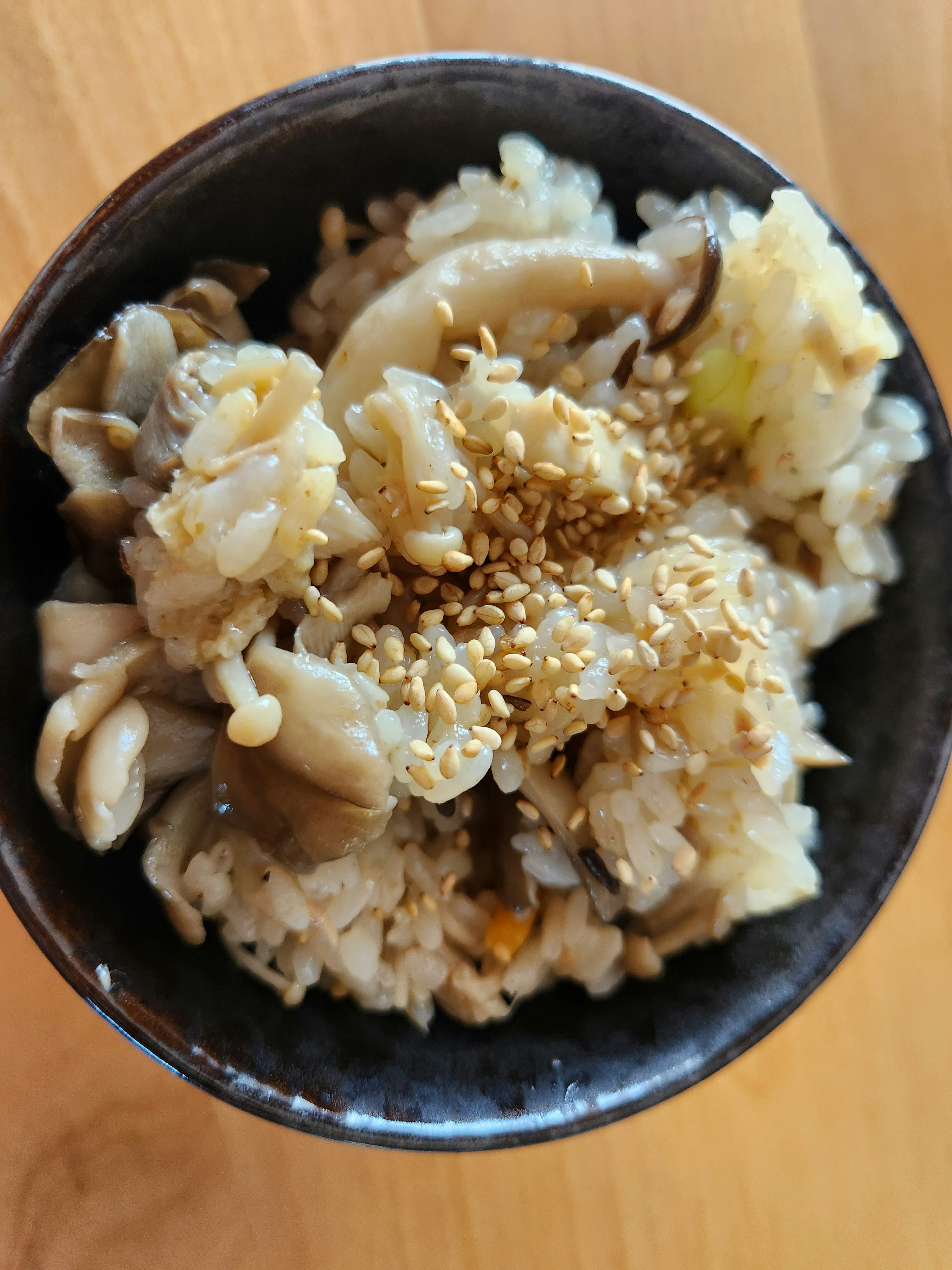 bowl of mushroom rice topped with sesame seeds